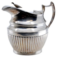 Fluted silver milk jug with half-body design and knobbed lid