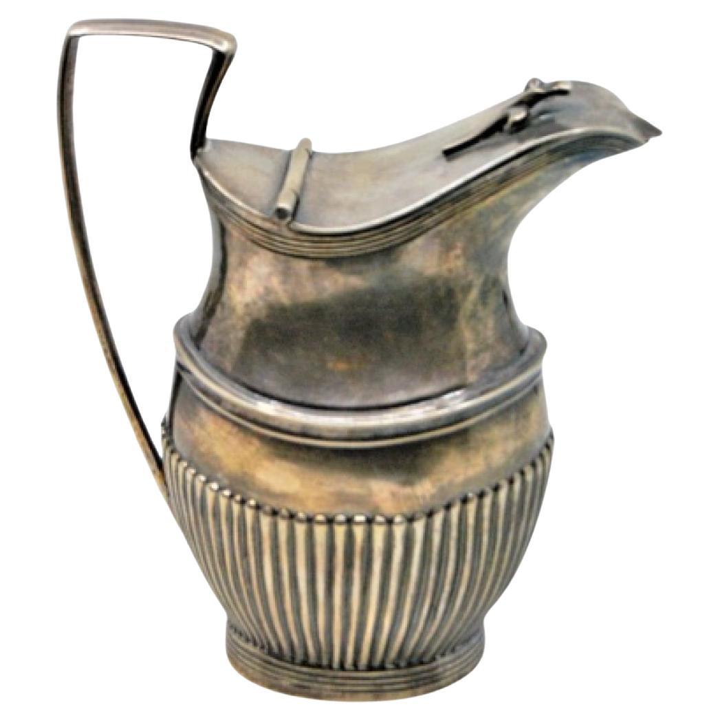 Fluted silver milk jug with rim friezes and knobbed lid in D. Maria style