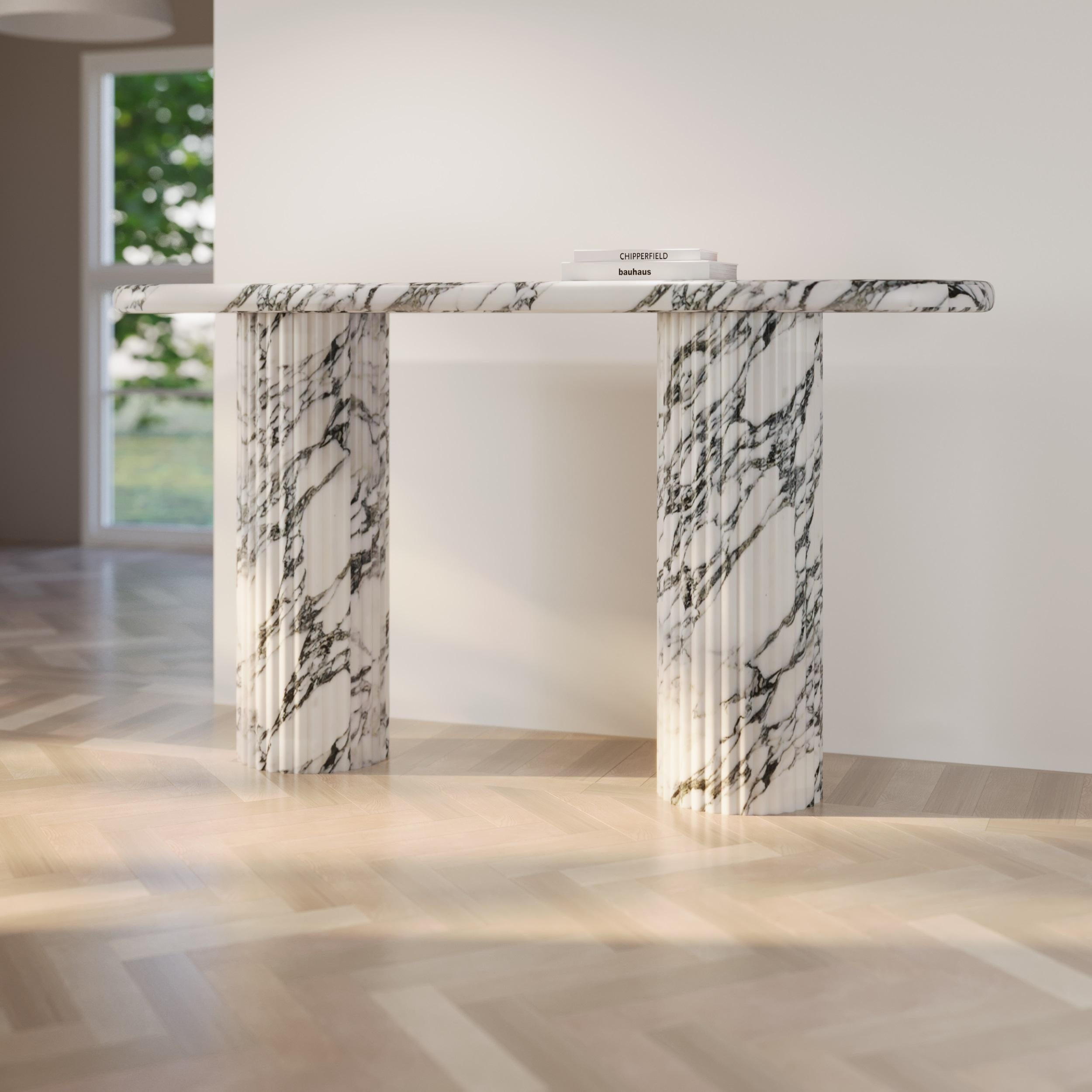 ntroducing the embodiment of sophistication and artistry in furniture design – the Marble Fluted Round Console Table. This exquisite piece transcends traditional concepts of home decor, seamlessly blending opulence with functionality to create a