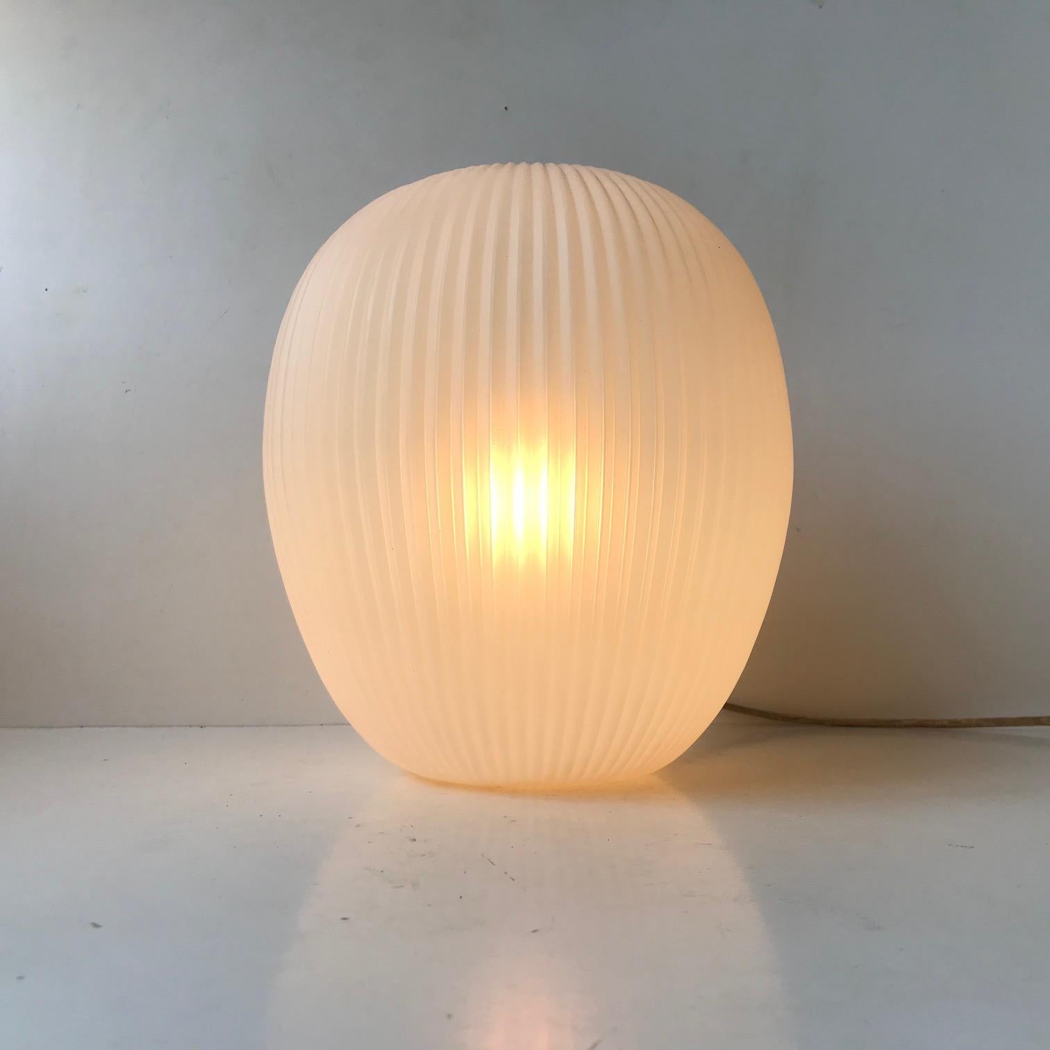 A rare vertically fluted white pendant lamp by Rotoflex. It has an ovoid shape perfectly balanced. Its is made from acrylic and is very light. Lightsource: E27 up to 250 Watts. Measurements: H: 28 cm, D: 25 cm.