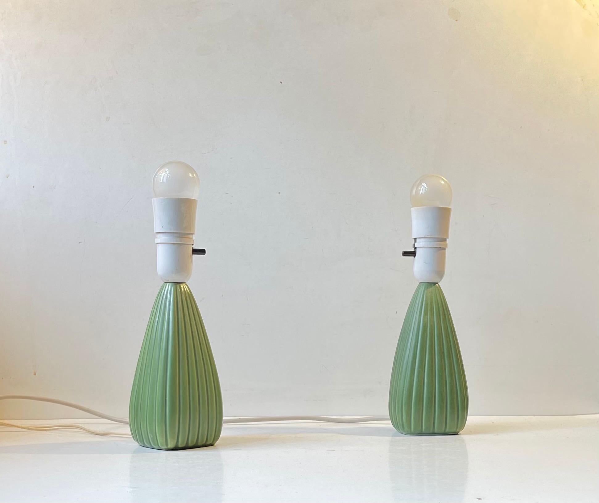 A pair of ceramic pumpkin table lamps featuring horizontal ribbings and light green glaze. Designed by Einar Johansen and manufactured by Søholm in Denmark in early 1970s. The style is reminiscent of Arne Bang and Eslau in particular. The white