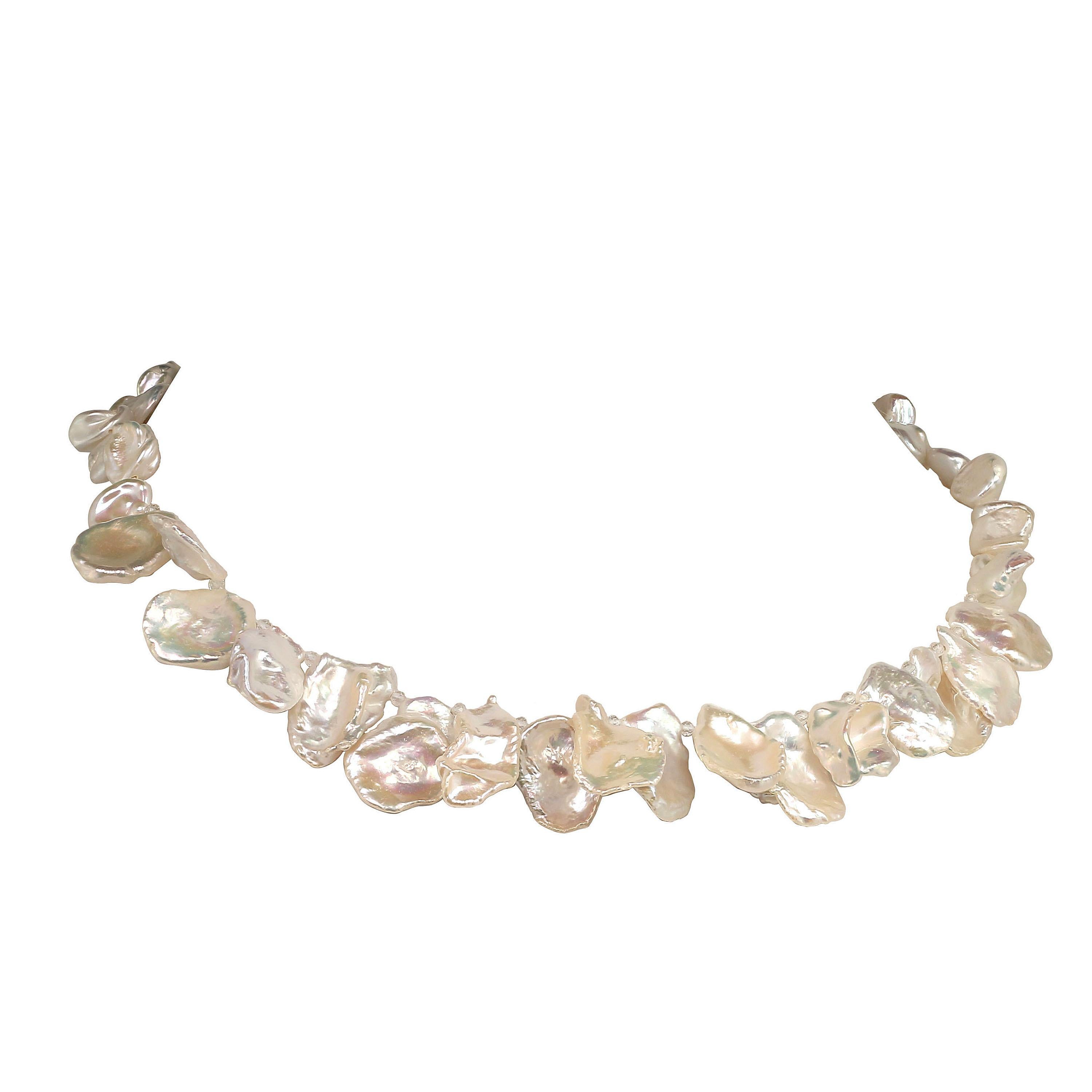 Playful, handmade choker necklace of iridescent, white Keshi Pearls in two sizes, larger across the front and more delicate around the back is a must for your jewelry wardrobe. It flutters its way right into your heart. This choker necklace is 16.5