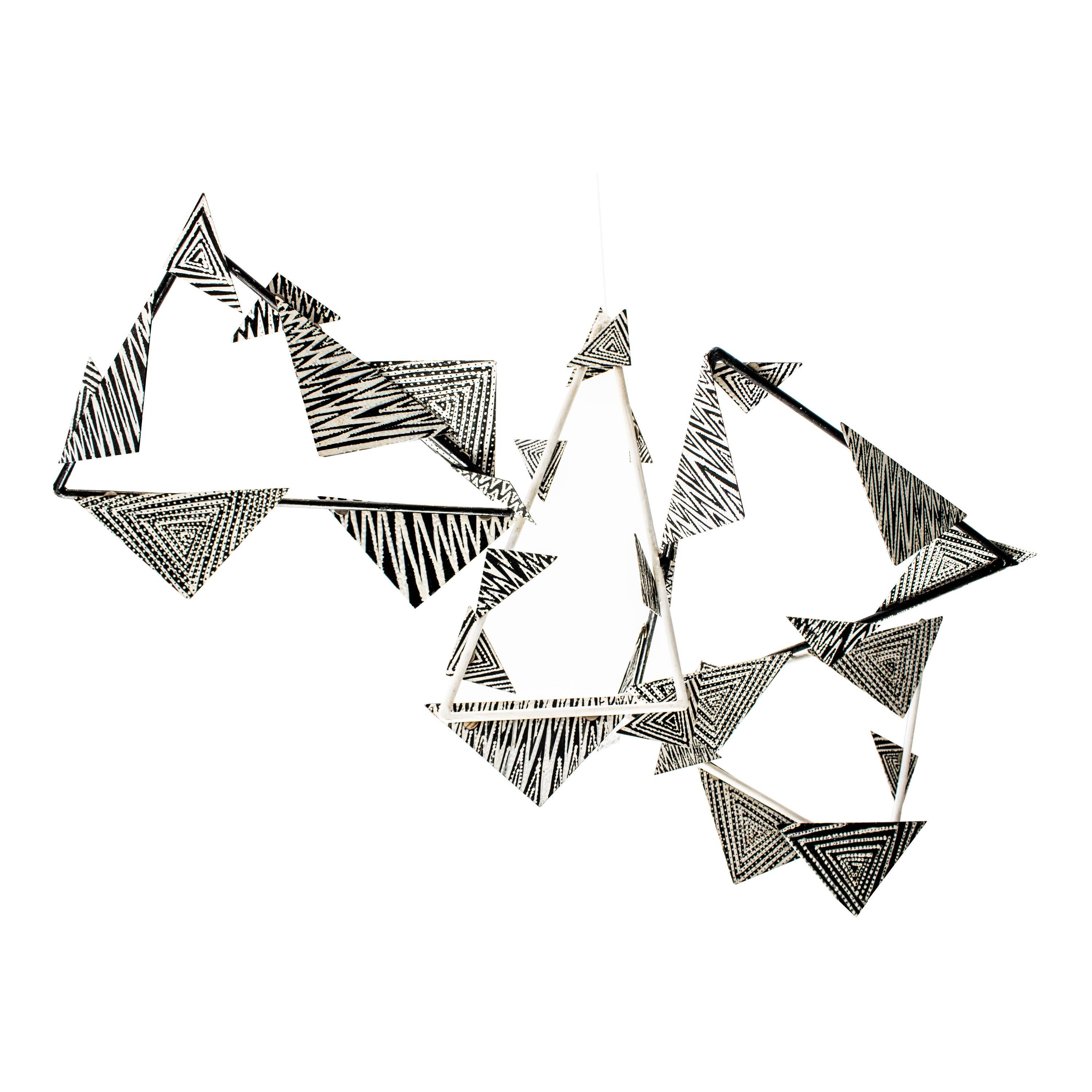 Mobile piece made by artist Layla D'Angelo. It is made of iron with geometric shapes and white applications with nail polish.

BIO:

Layla D'Angelo, born in New York in 1953, is a prominent artist who has lived in Spain since 1988. In 1987, she