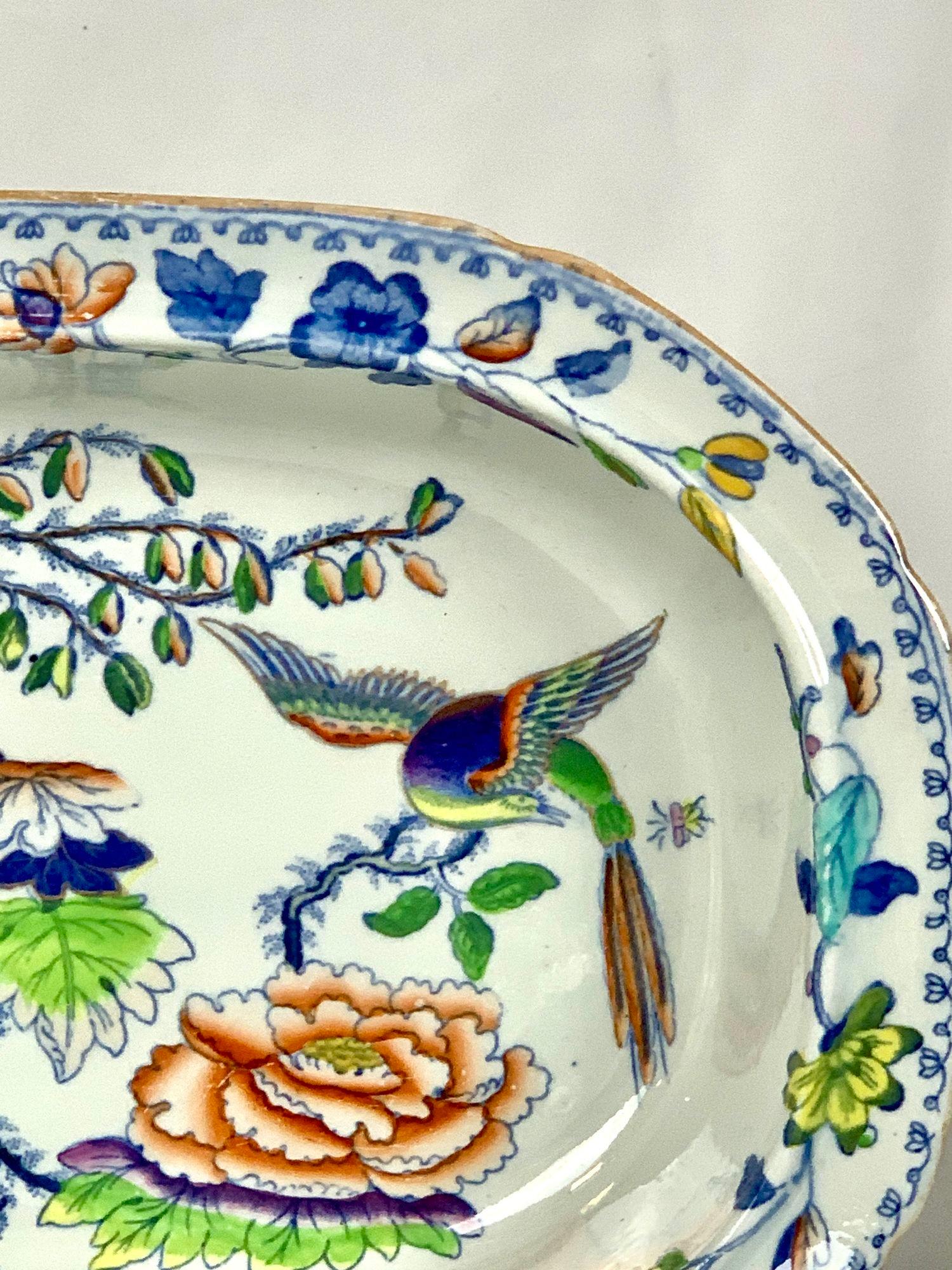 This oval bowl in the gorgeous Flying Bird pattern has everything you want in a colorful pattern: a beautiful bird and flowers painted in rainbow colors.
The colors are an unexpected combination of purple, pink, yellow, orange, deep cobalt blue, and