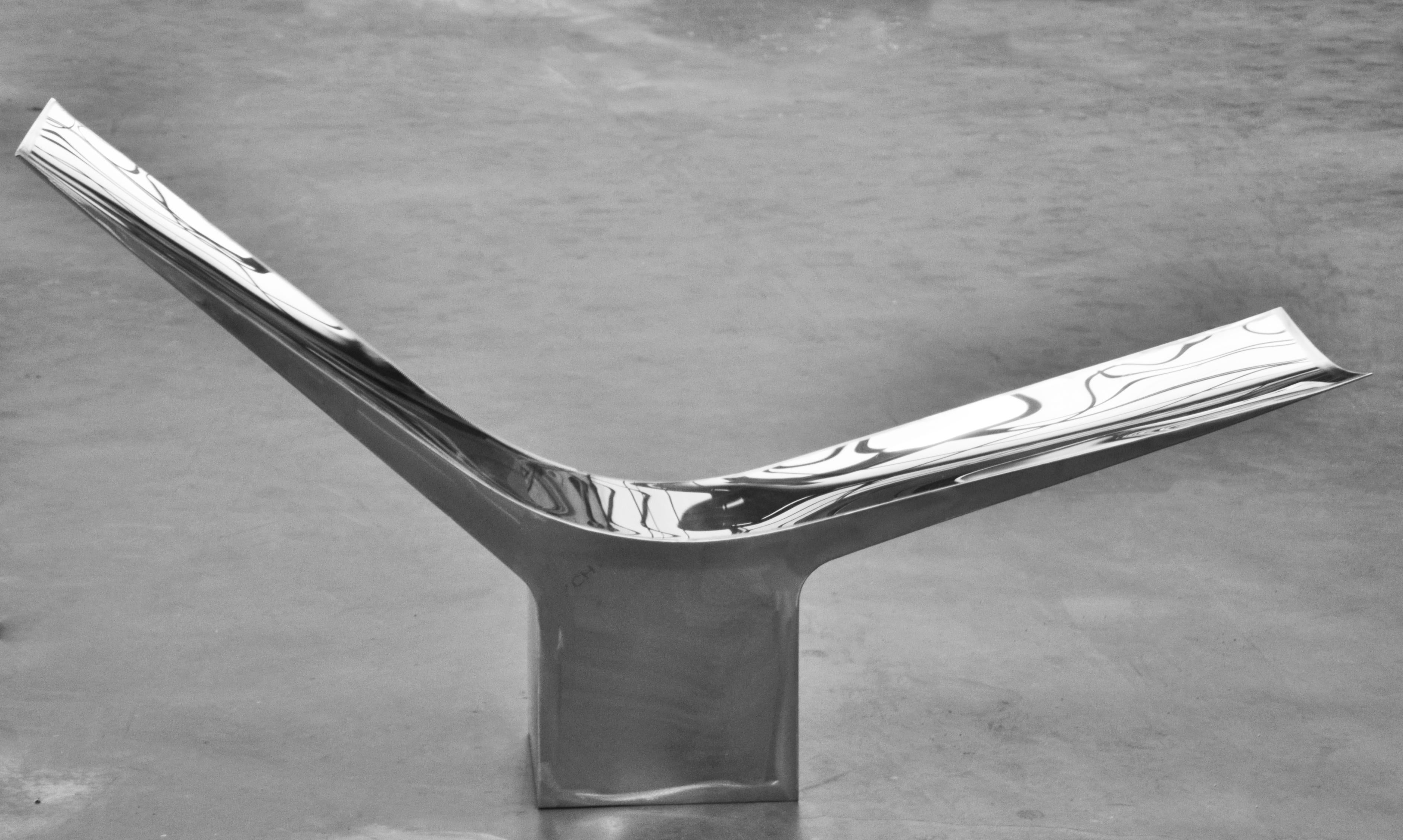 Flying Chair by Pol Quadens 
Limited Edition Of 8+4 Pieces.
Dimensions: D 55 x W 200 x H 90 cm.
Materials: Polished stainless steel.

Pol Quadens was born in Brussels. His father was active in the fields of composites the metal industry, and the