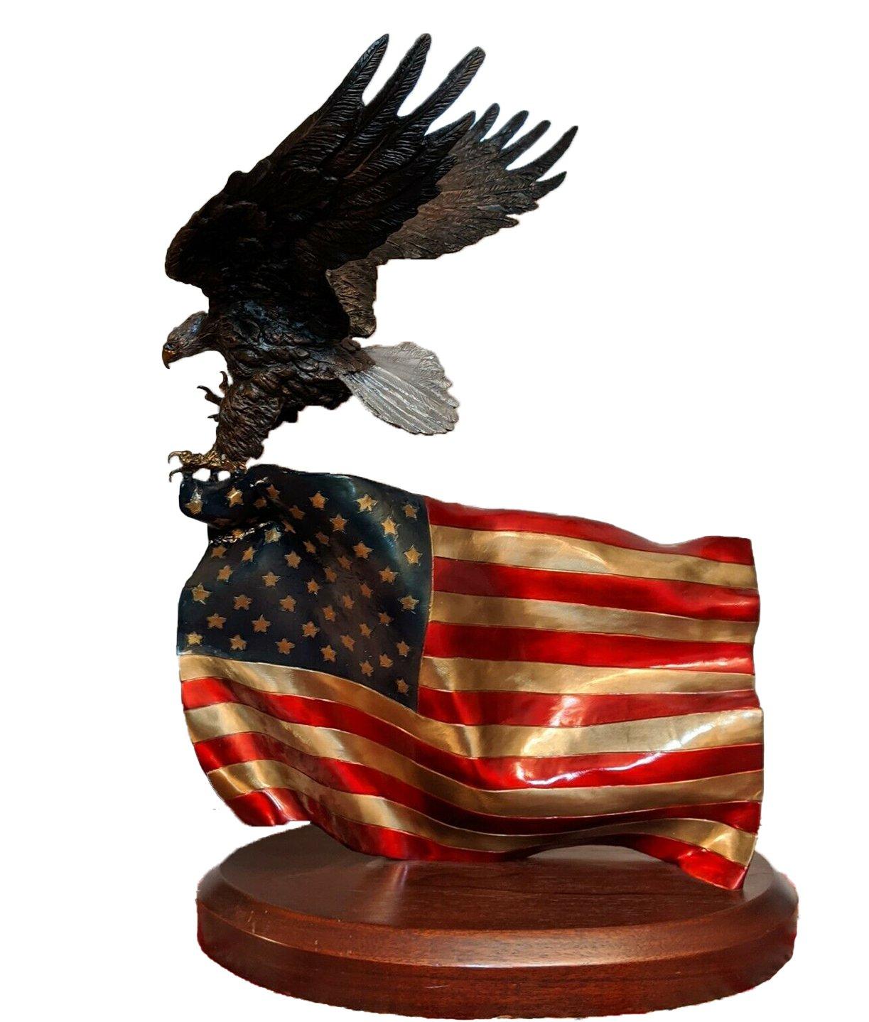 This bronze sculpture by the renowned Lorenzo Ghiglieri is titled Flying Colors. Created in 2001, the bronze features a bald eagle soaring determinedly while clutching the American Flag with its talon. The bronze is wonderfully detailed to show the