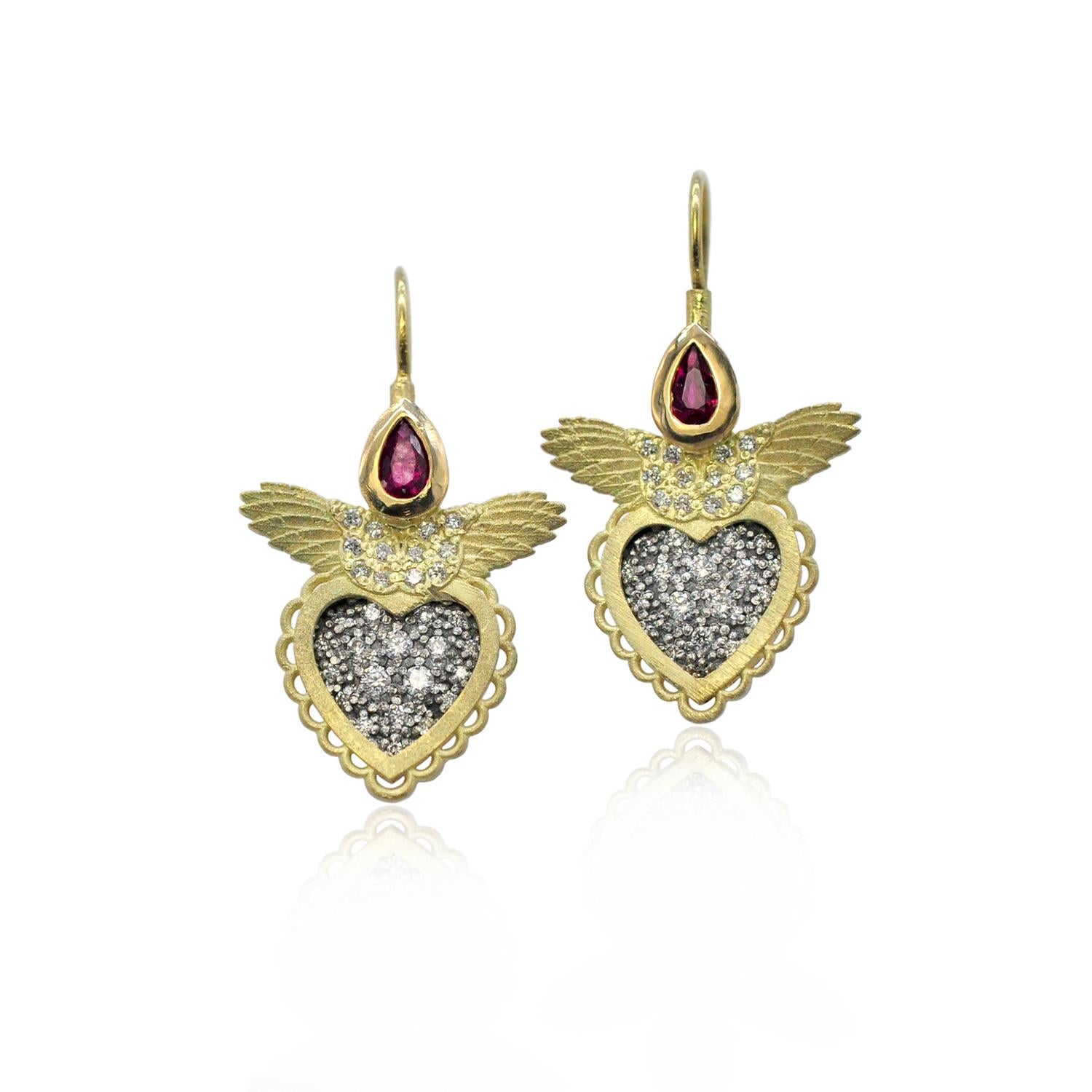 Oxidized silver centers glimmer with pave set diamonds inside a bright 18k yellow gold scalloped valentine style heart. Our signature textured feathers with more pave set diamonds are topped with juicy red faceted, pear shaped rubies. The earrings