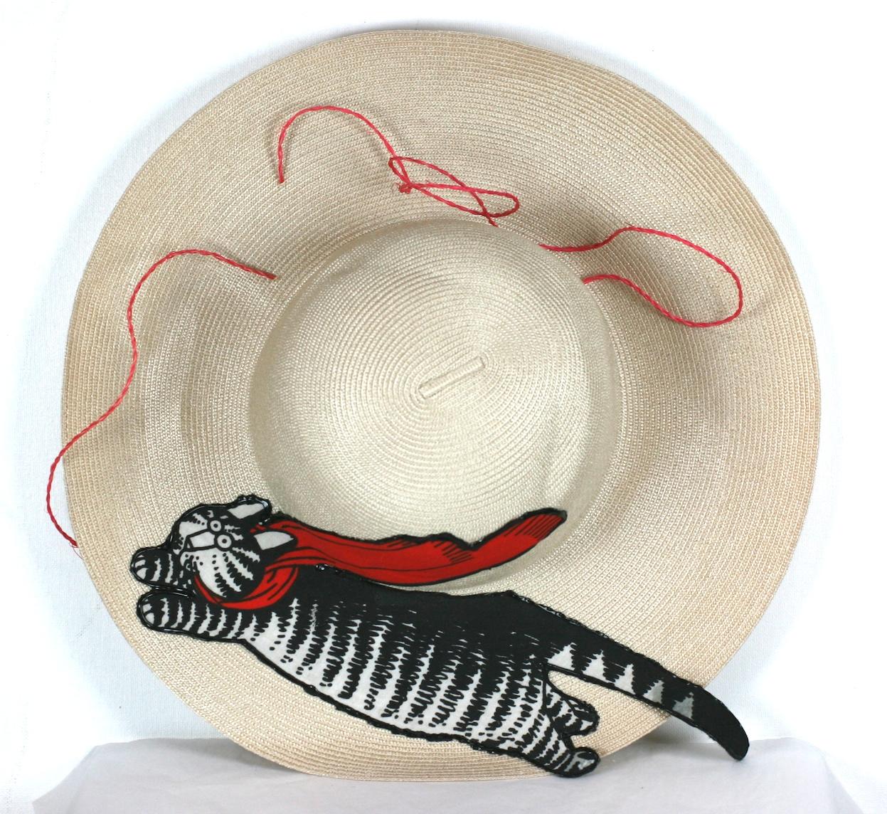 Charming Straw hat with applied flying Kliban cat in mid flight chasing red string woven around brim. Motif is the famous flying cat by cartoonist Bernard Kliban.
Perfect for channeling your future crazy cat lady outfits. 
Brim 4