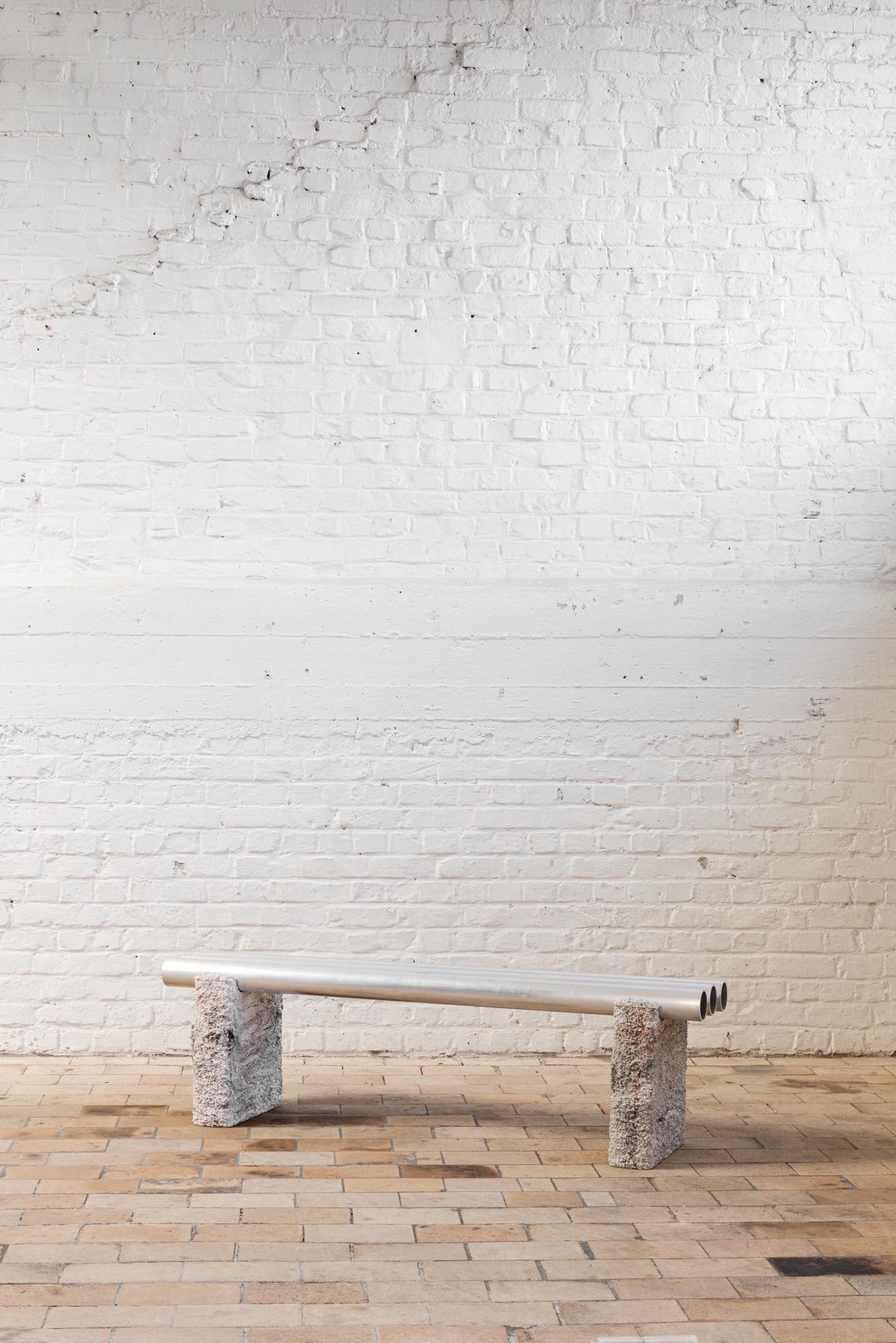 Foam bench by Arne Desmet
Dimensions: D150 x W34 x H 44 cm
Materials: Base: casted white concrete with color pigment, tubes: aluminium.

Foam bench is composed of two concrete blocks and 3 extruded aluminium tubes. The mold for the concrete