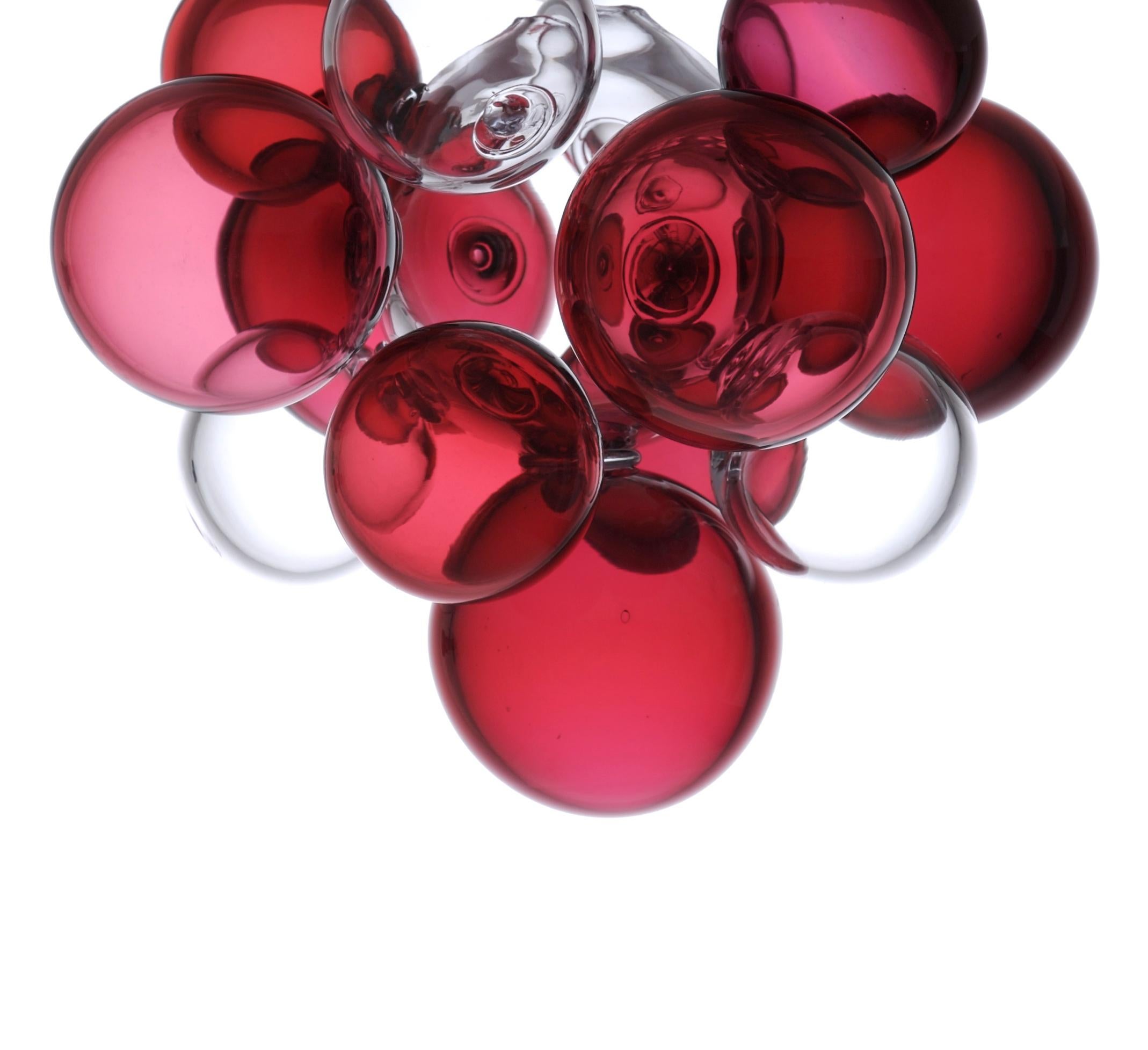 Glass pendant made of hand blown and shaped glass. An organic design in the style of feminine fluidity with simple lines, an artistic light object of utility that goes beyond its function. It can fill every space with an unusual atmosphere and thus