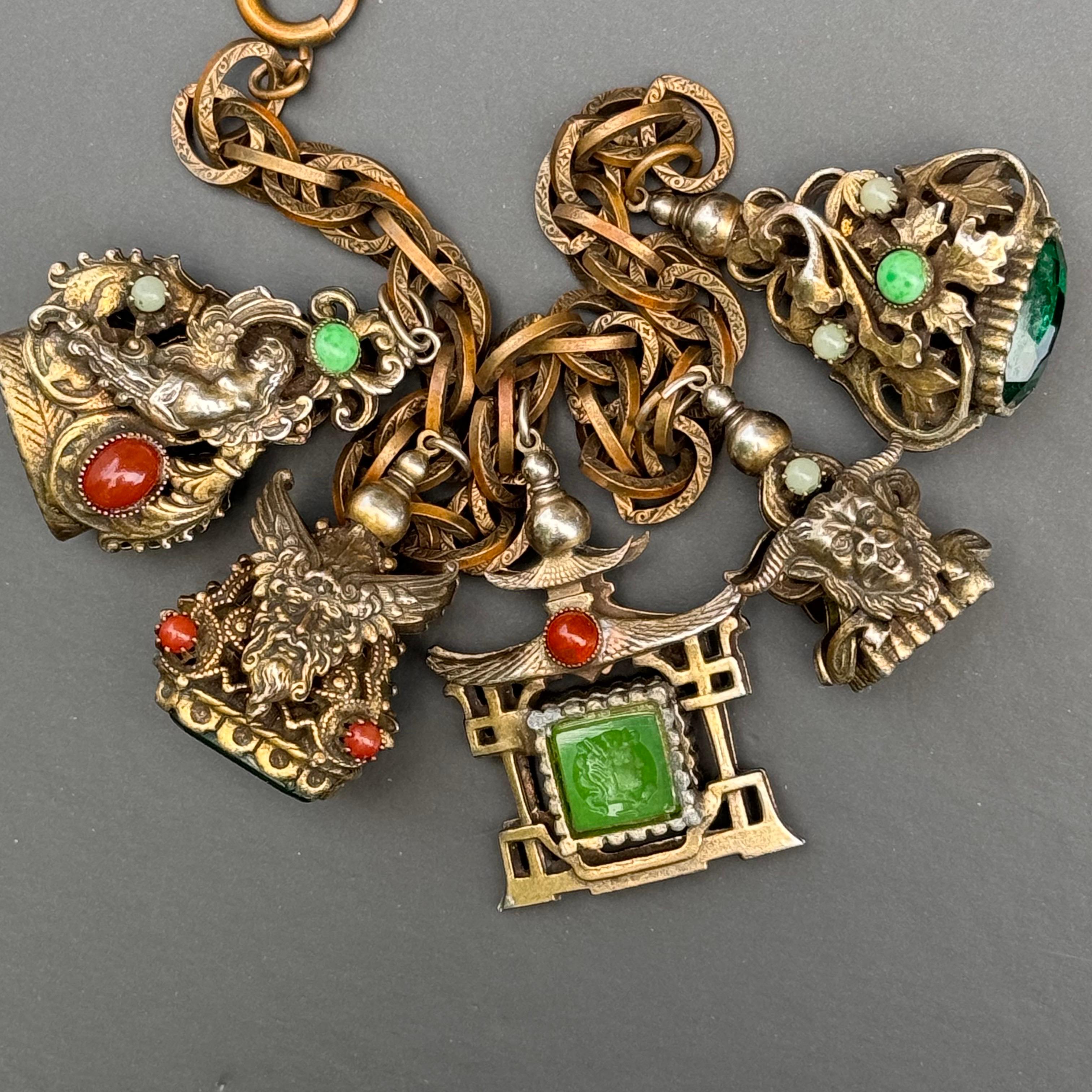 Step back in time with this exquisite vintage charm bracelet, dating back to the 1960s. This piece beautifully captures the essence of Victorian and Renaissance revival styles.
Featuring  5 ornate fob /charms attached to a wide chain with original