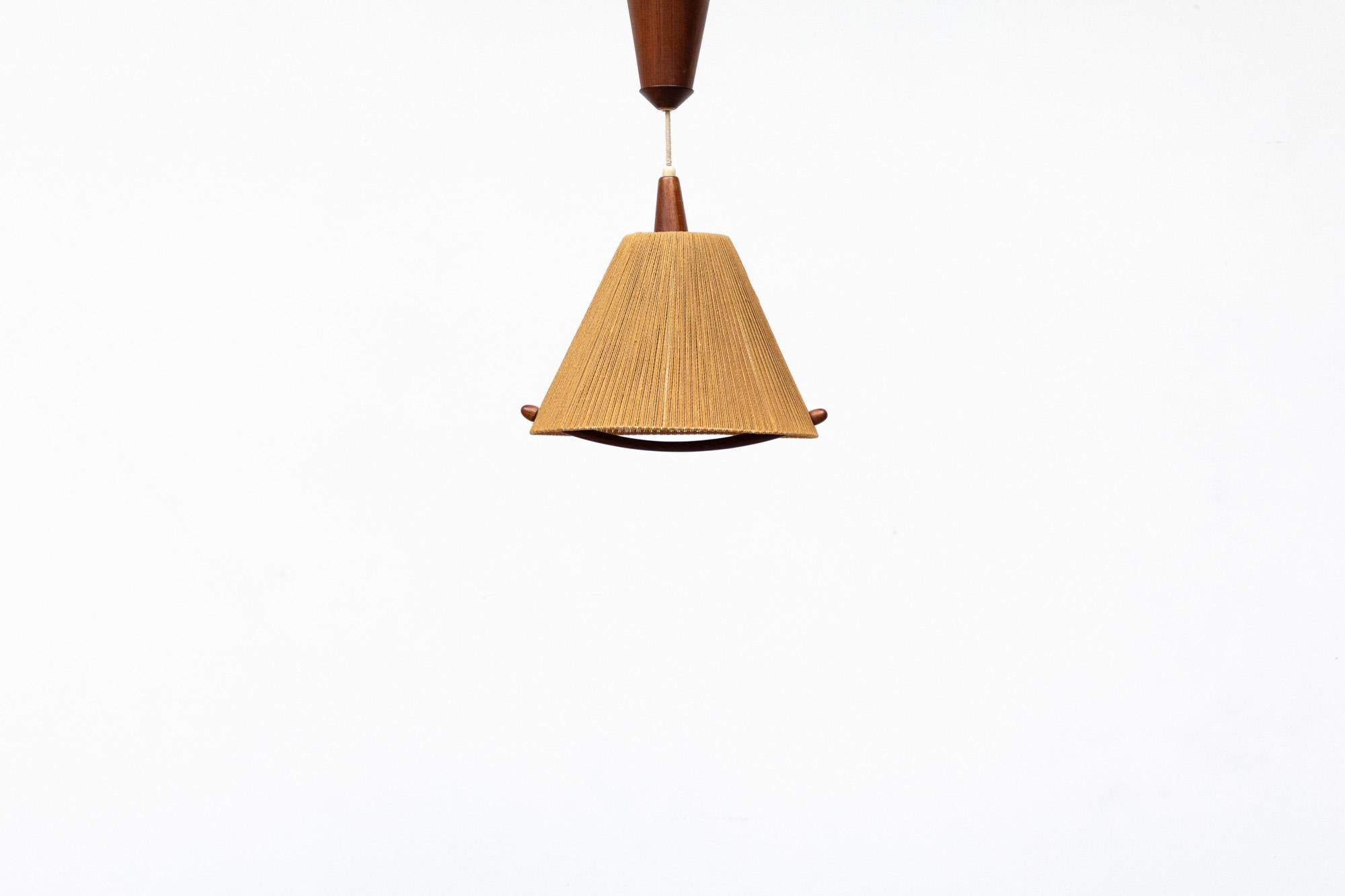 Rare fog and morup teak and jute pendant lamp with a unique pulley system built into the canopy that allows for easy height adjustment. Designed by Ib Fabiansen, Denmark, 1960's. Gives off an appealing ambient glow when lit. In original condition