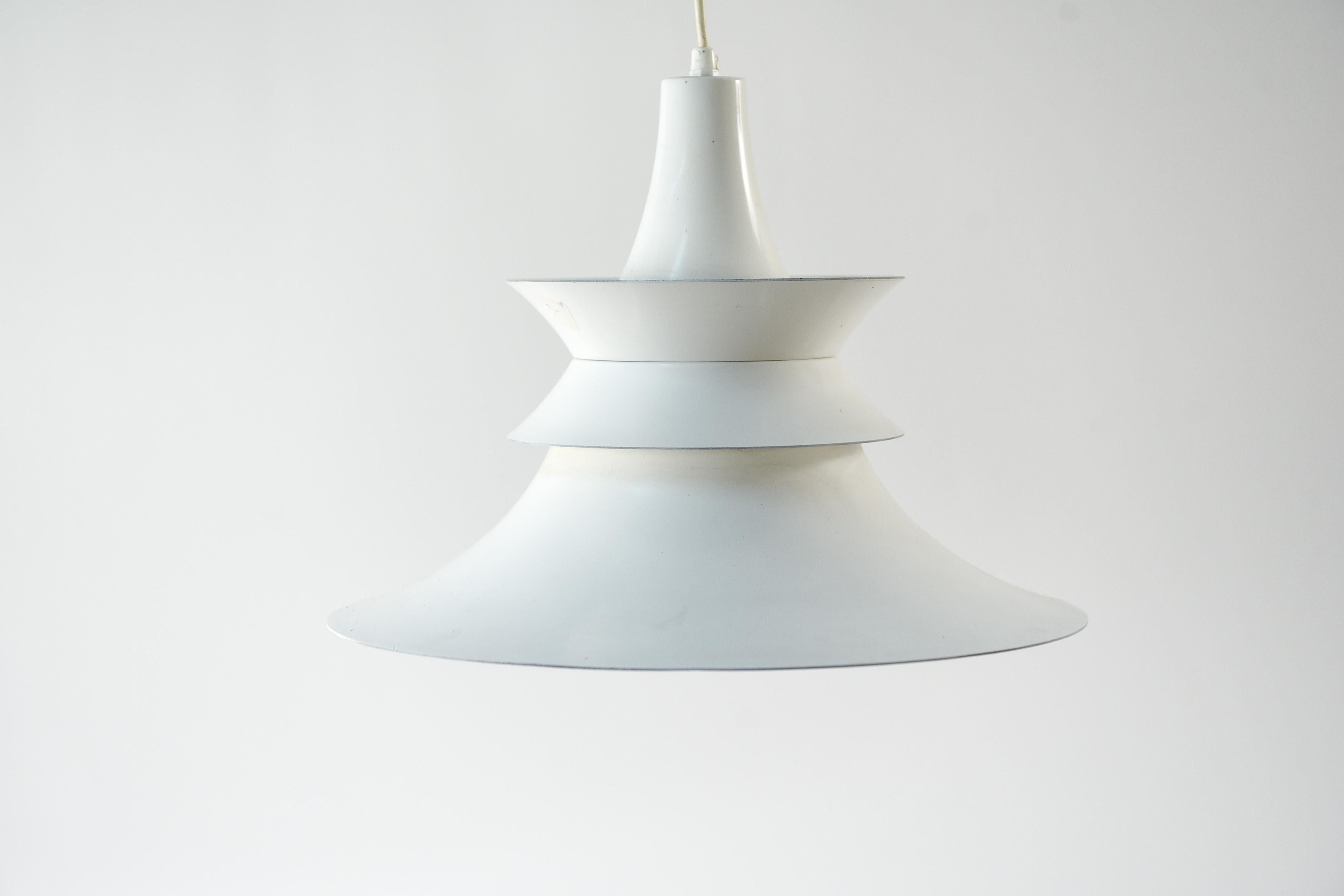 This Danish midcentury pendant light was produced by Fog and Morup. The 1960s design is attributed to Erik Balslev, and features clean modern lines, complemented by the white color of the pendant.