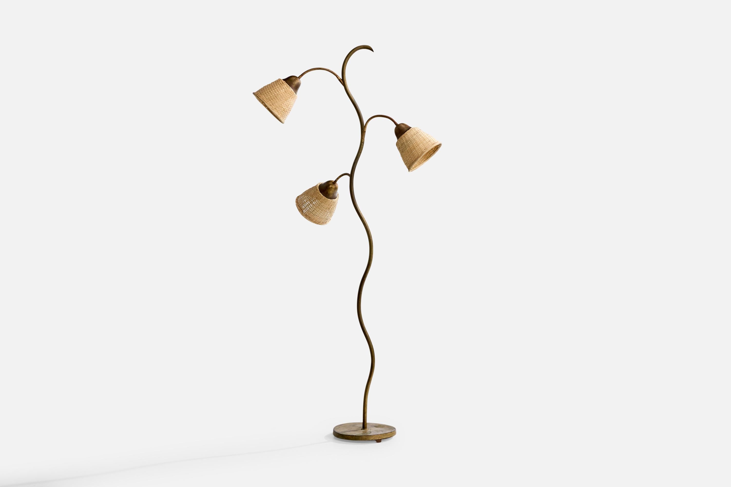 An adjustable brass and rattan floor lamp produced by Fog & Mørup, Denmark, c. 1940s.

Moderate to heavy oxidation present throughout lamp.

Dimensions of Lamp with Shade (inches): 64.625