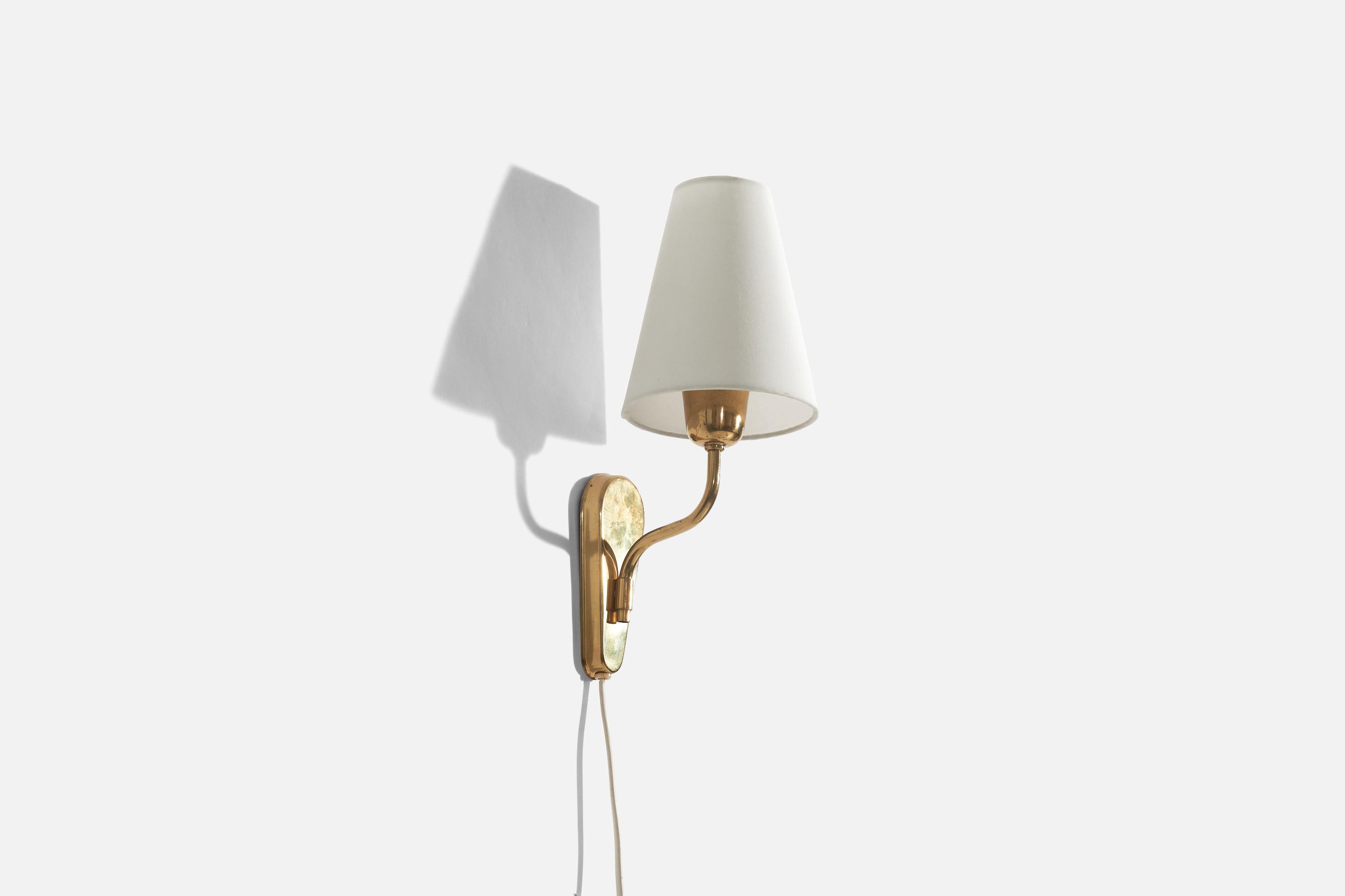A brass and fabric sconce designed and produced by Fog & Mørup, Denmark, c. 1950s.

Sold with lampshade. 
Stated dimensions refer to the Sconce with the Shade. 
Dimensions of back plate (inches) : 6 x 2.5 x 0.67 (H x W x D).