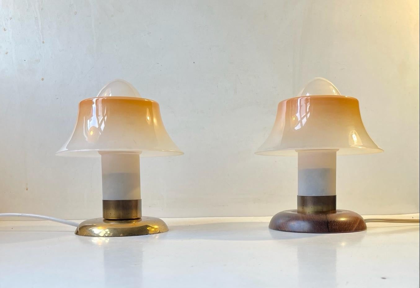 A rare set of small table lights. They are made from brass and frosted/partially painted single layered glass. Please notice they diffrent bases. They were manufactured by Fog & Mørup in Denmark during the 1940s or 50s and is stylistically 'related'