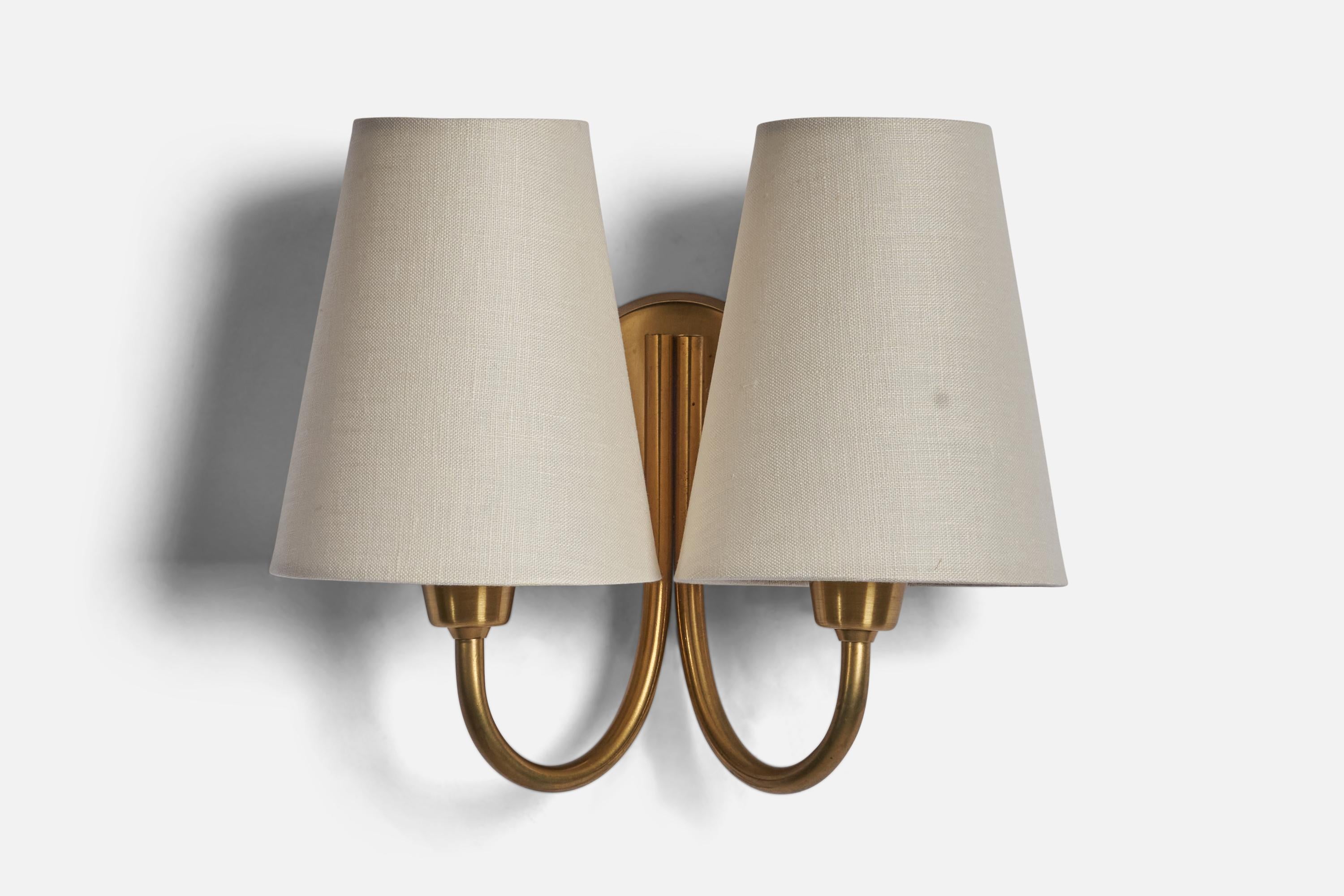 A two-armed brass and fabric wall light designed and produced by 
Fog & Mørup, Denmark, c. 1950s.

Overall Dimensions (inches): 8” H x 9.5” W x 5” D
Bulb Specifications: E-14 Bulb
Number of Sockets: 2
All lighting will be converted for US usage. We