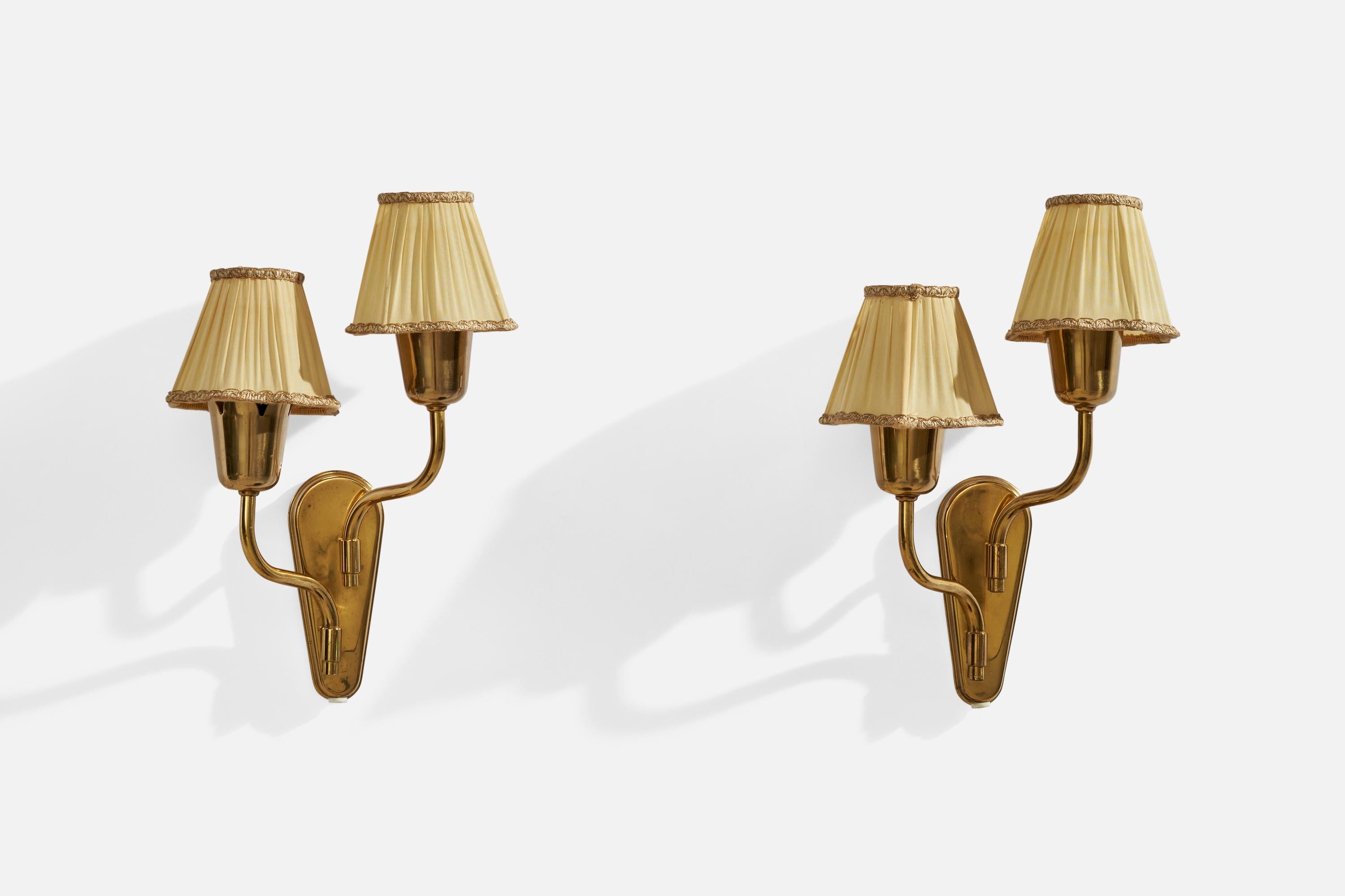 A pair of brass and beige fabric wall lights, designed and produced by Fog & Mørup, Denmark, c. 1940s.

Overall Dimensions (inches): 13.5”  H x 9” W x 5.25” D
Back Plate Dimensions (inches): 6”  H x 2.25”  W x .75” D
Bulb Specifications: E-14