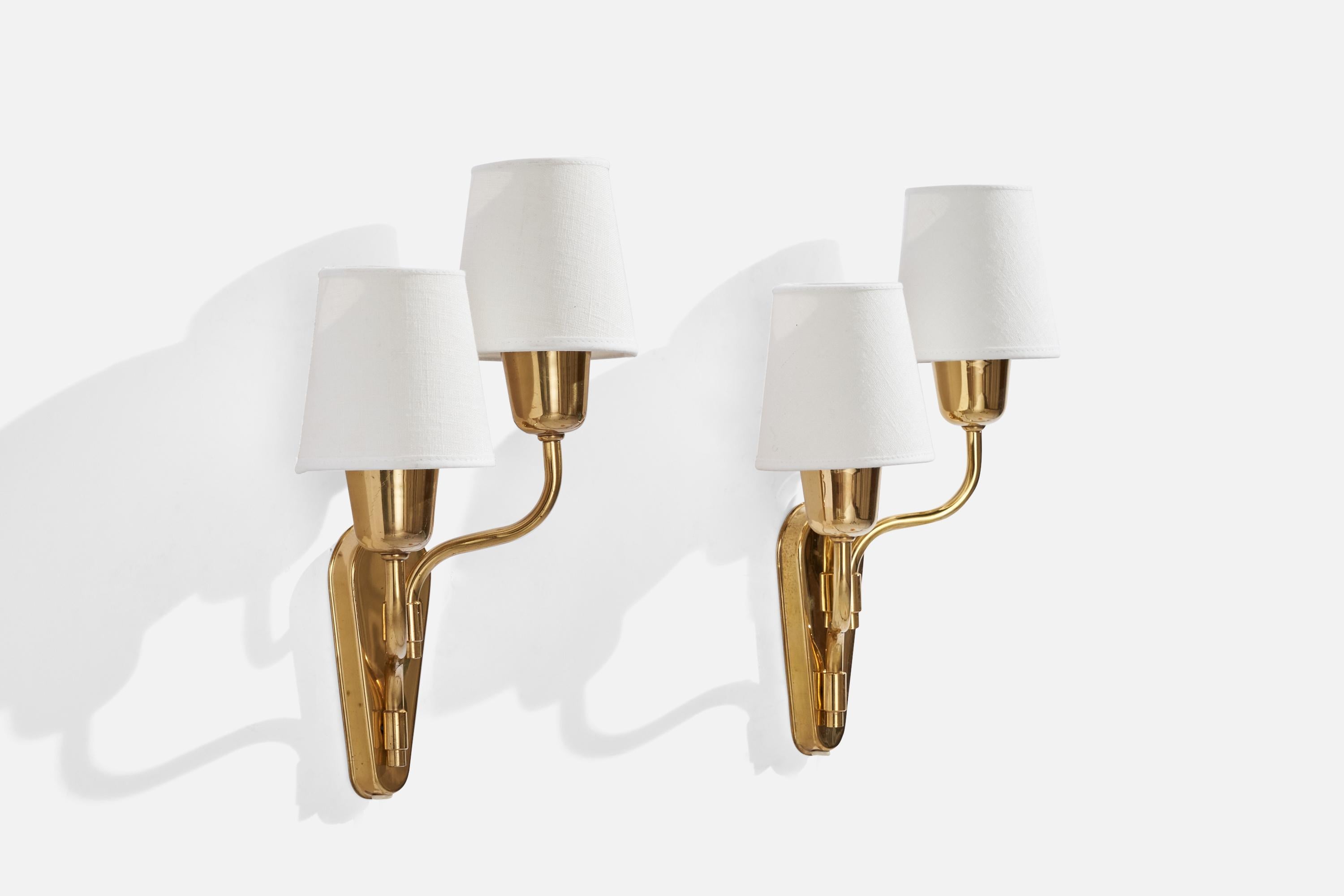  A pair of brass and white fabric wall lights, designed and produced by Fog & Mørup, Denmark, c. 1940s.

Overall Dimensions (inches): 13.5” H x 9” W x 5” D
Back Plate Dimensions (inches): 5.9” H x 2.45” W x 0.70” D
Bulb Specifications: E-26