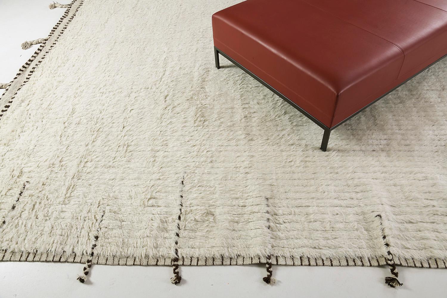 Fohn' is a handwoven luxurious wool rug with impressive embossed line detailing. In addition to its ivory-toned pile-weave, Fohn has a perfect shag that brings a lustrous and contemporary feel to one's space. The Haute Bohemian collection is