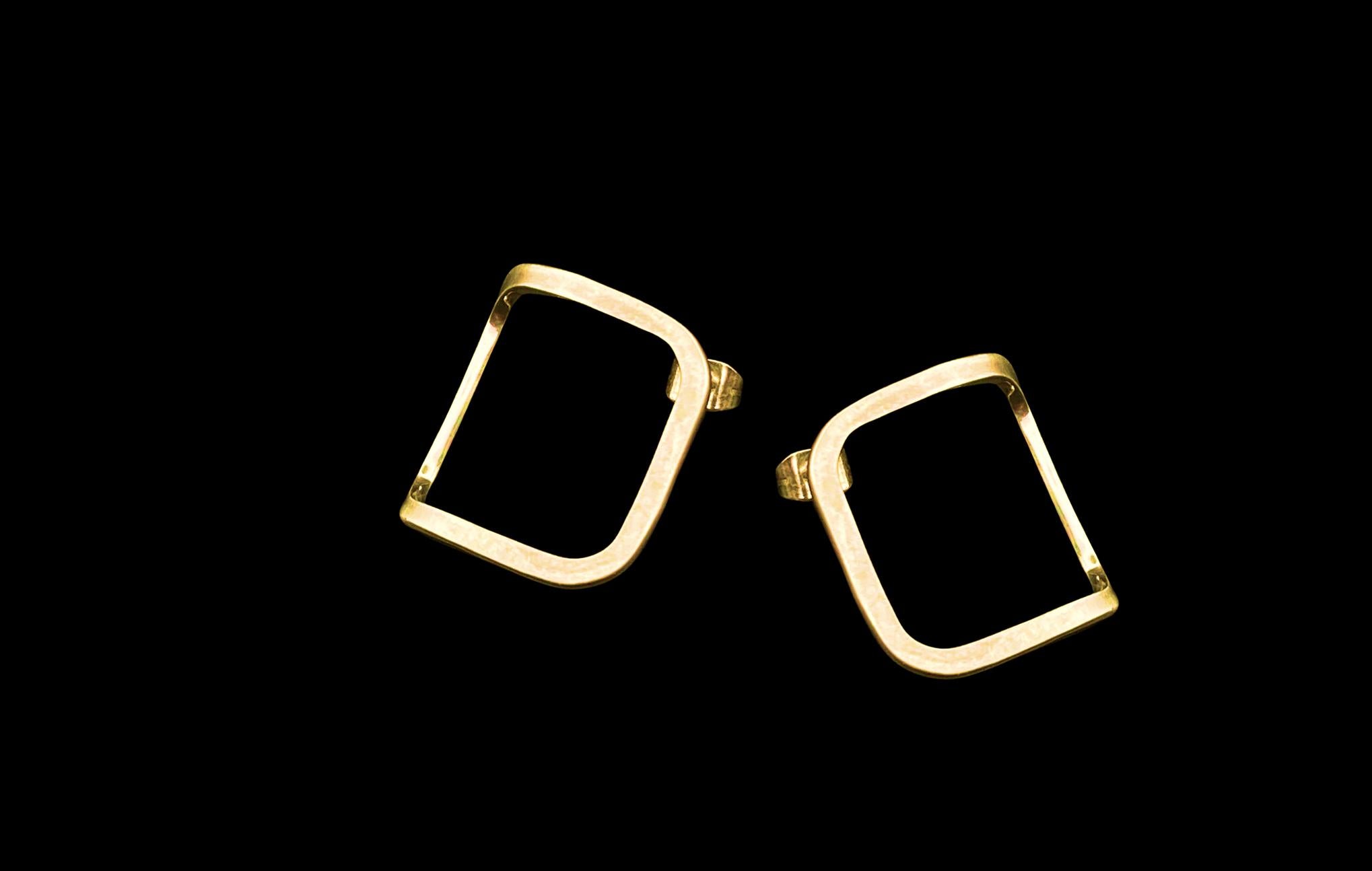 Elegant stud earrings made from forged wire, formed into a folded square. 

The polished inside surface is highlighted by the fold and catches the light when worn. 

They are secured to the ear with a classic butterfly back, and are a comfortable