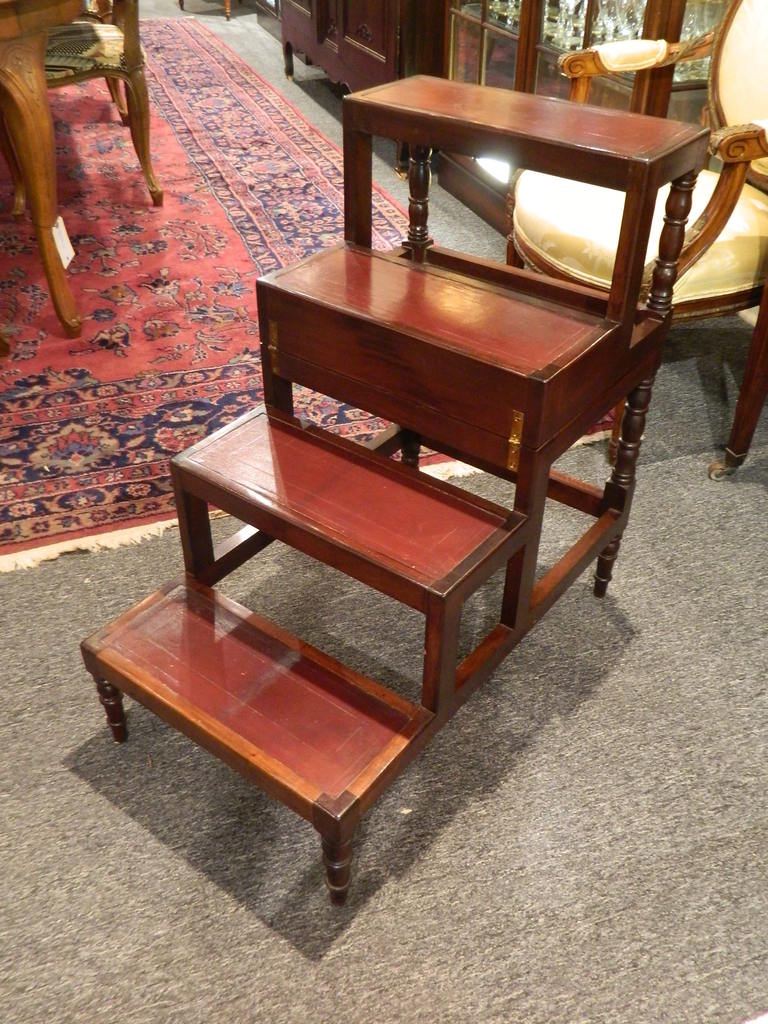 Late 19th century Sheraton style mahogany fold over bed step ladder or table on turned legs. Each step is covered with leather. Dimensions as a table: 28.25