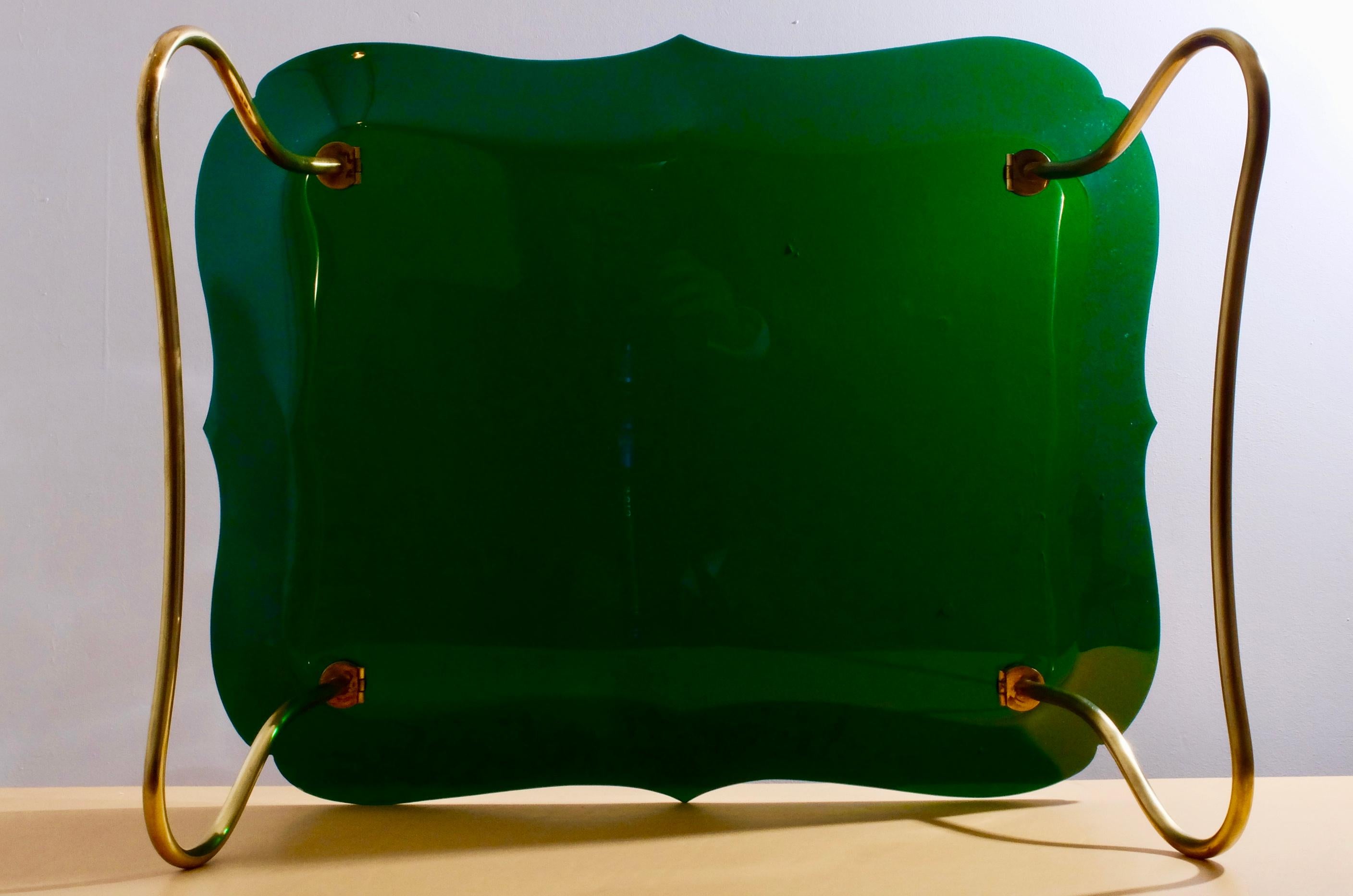 British racing green plastic and foldable brass legs by Jean Burkhalter.
 