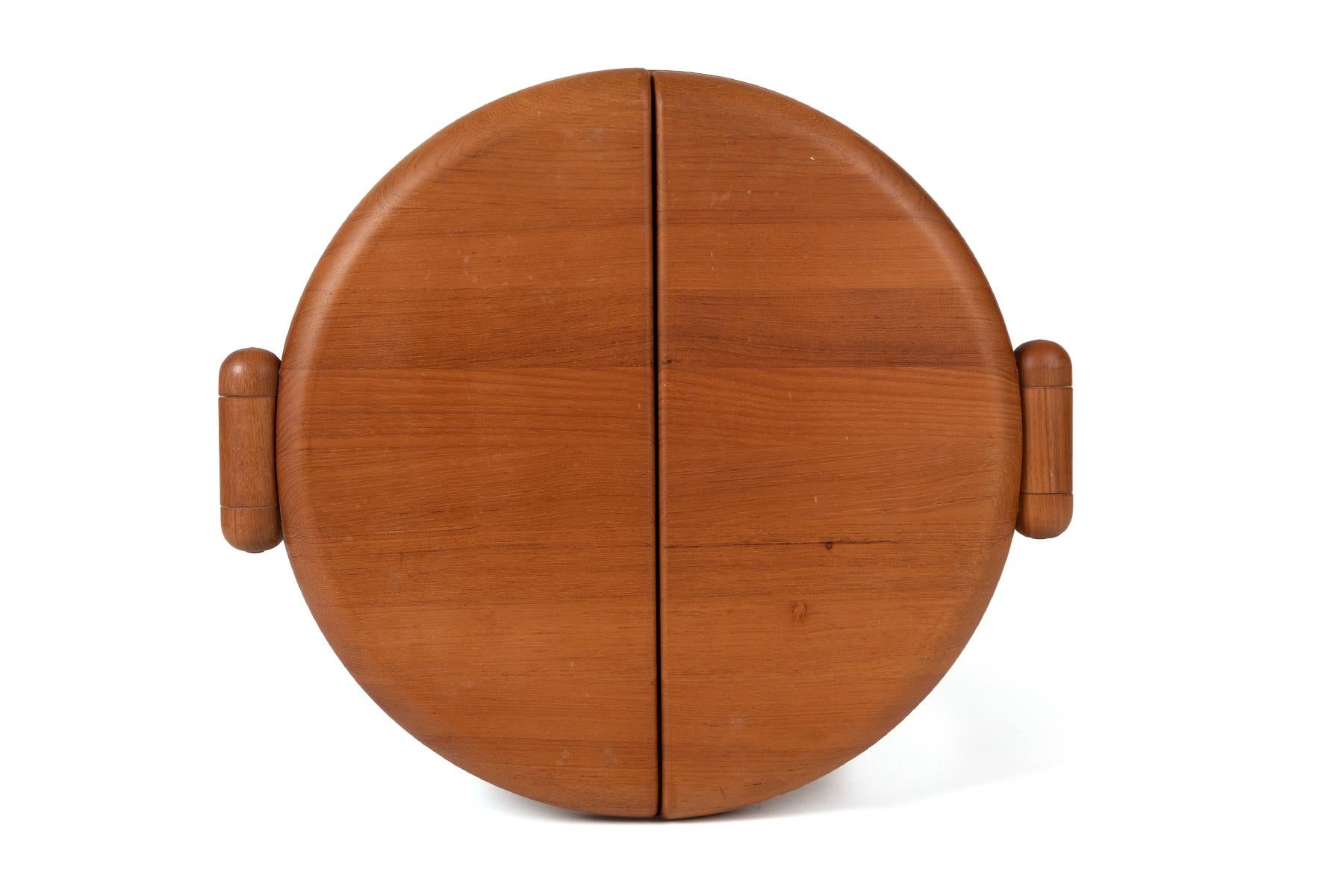 This unusual circular Danish teak table-top mirror has two half-moon sides that fold out to provide multiple angles. Can be wall mounted or used on a table top.