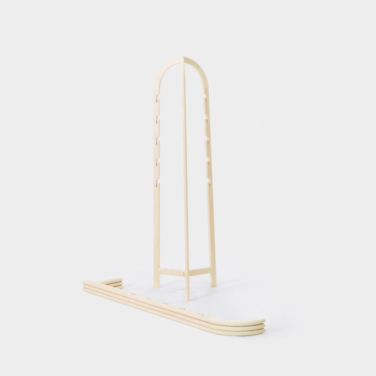 Scandinavian contemporary foldable coat hanger / clothes hanger made with precision craftsmanship and quality in material and design, materialised in ash wood, oak wood or blackened Ash. Foldable to be easily stored when not needed, clothes and bags