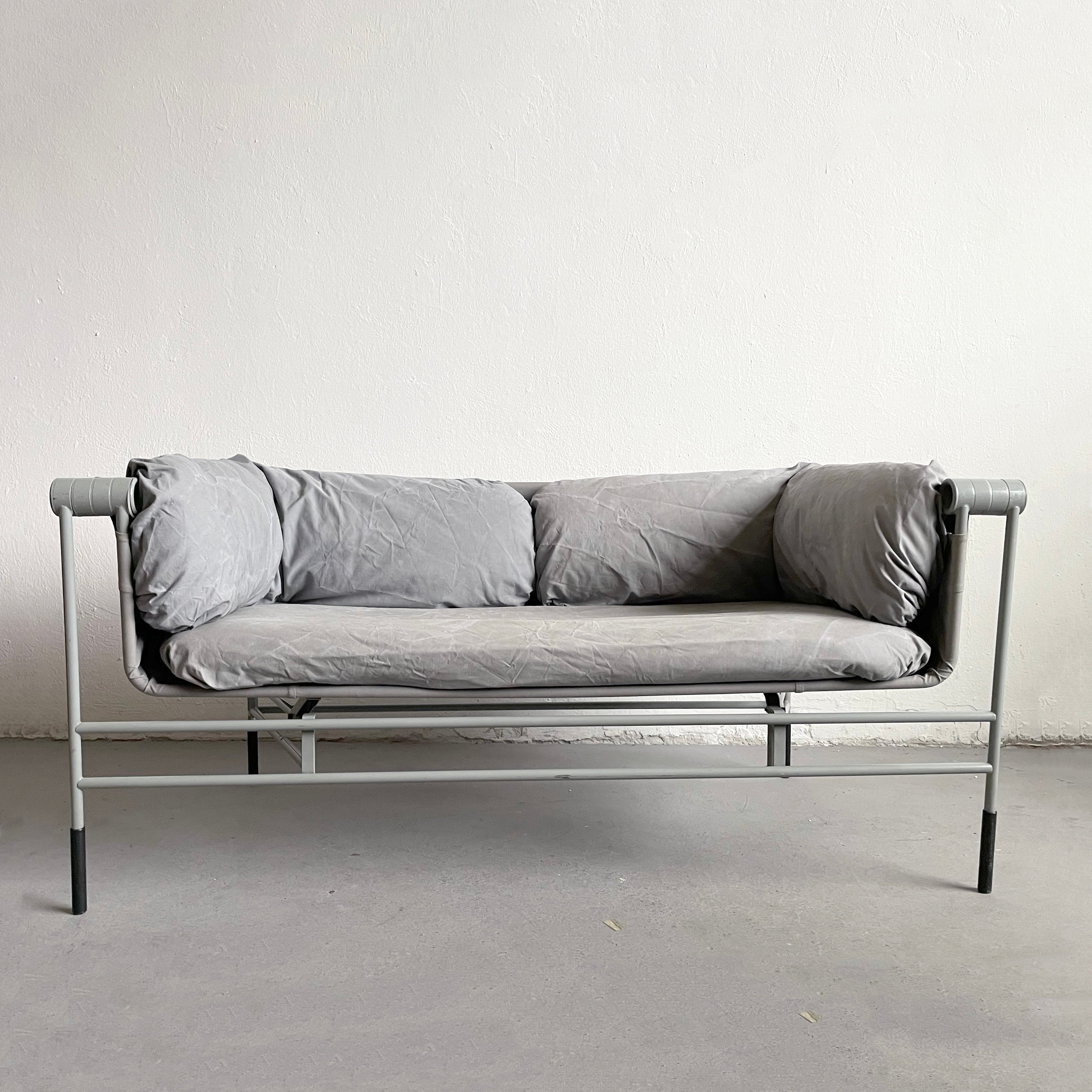 An extremely rare folding sofa with a gray lacquered steel frame, seat in stretched cloth with loose cushions by an unknown designer.

Period: Mid-Century Modern, 1980-1989

Place of origin: Italy

Material: Painted steel, Canvas

Dimensions: HxWxD