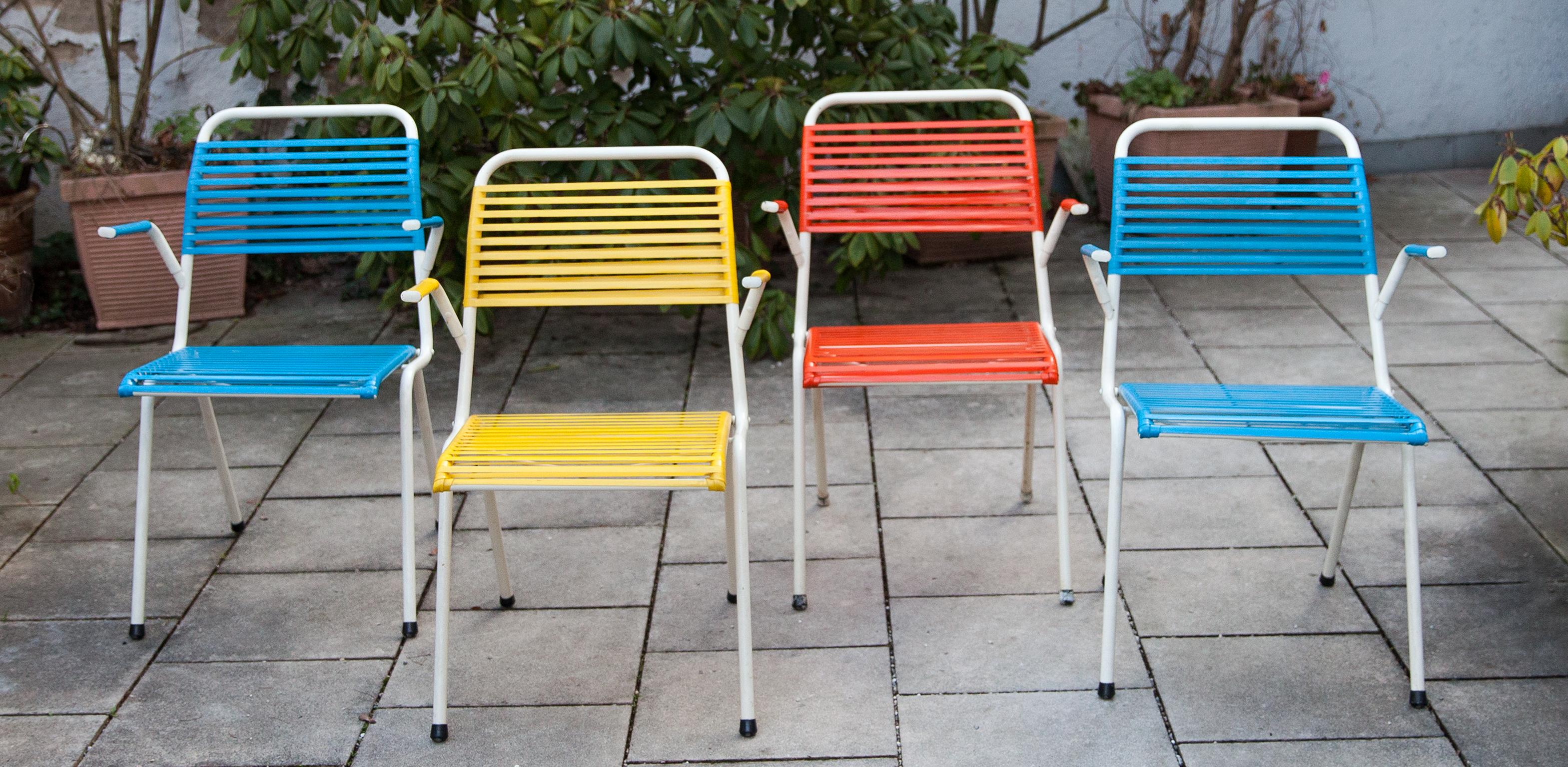 Set of four blue, yellow and red outdoor Spaghetti chairs with a white lacquered steel frame made by Arnold Germany in the 1950s, in a very good vintage condition.
Wonderful 1950s summer feeling on your terrace.

Measures; H 82 x W 55 x D 58 cm