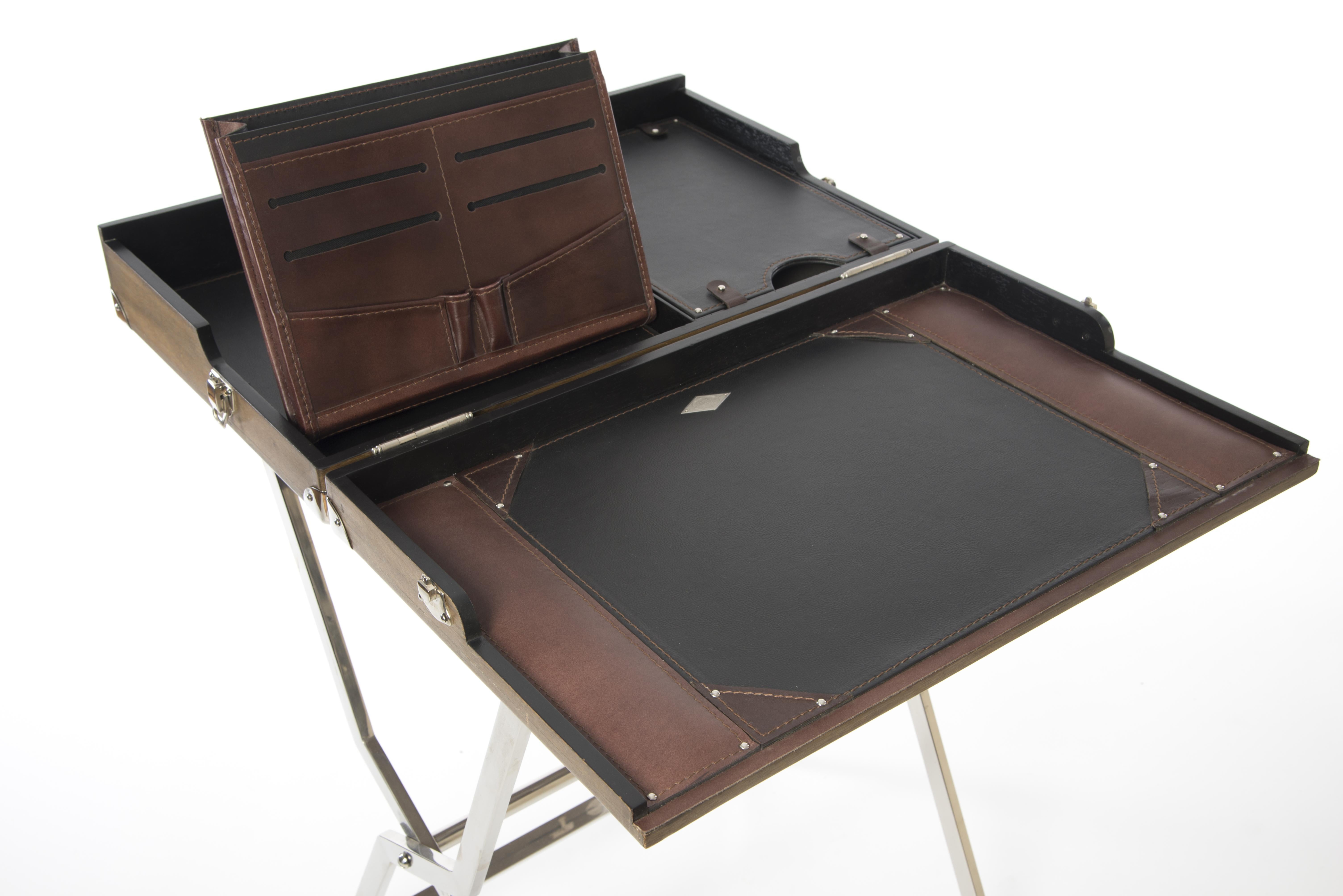 This foldable writing desk is made from mahogany in a driftwood finish with leather and nickel details. The folding legs are made from stainless steel. This interesting piece is not only practical but also unique. It has a very special 