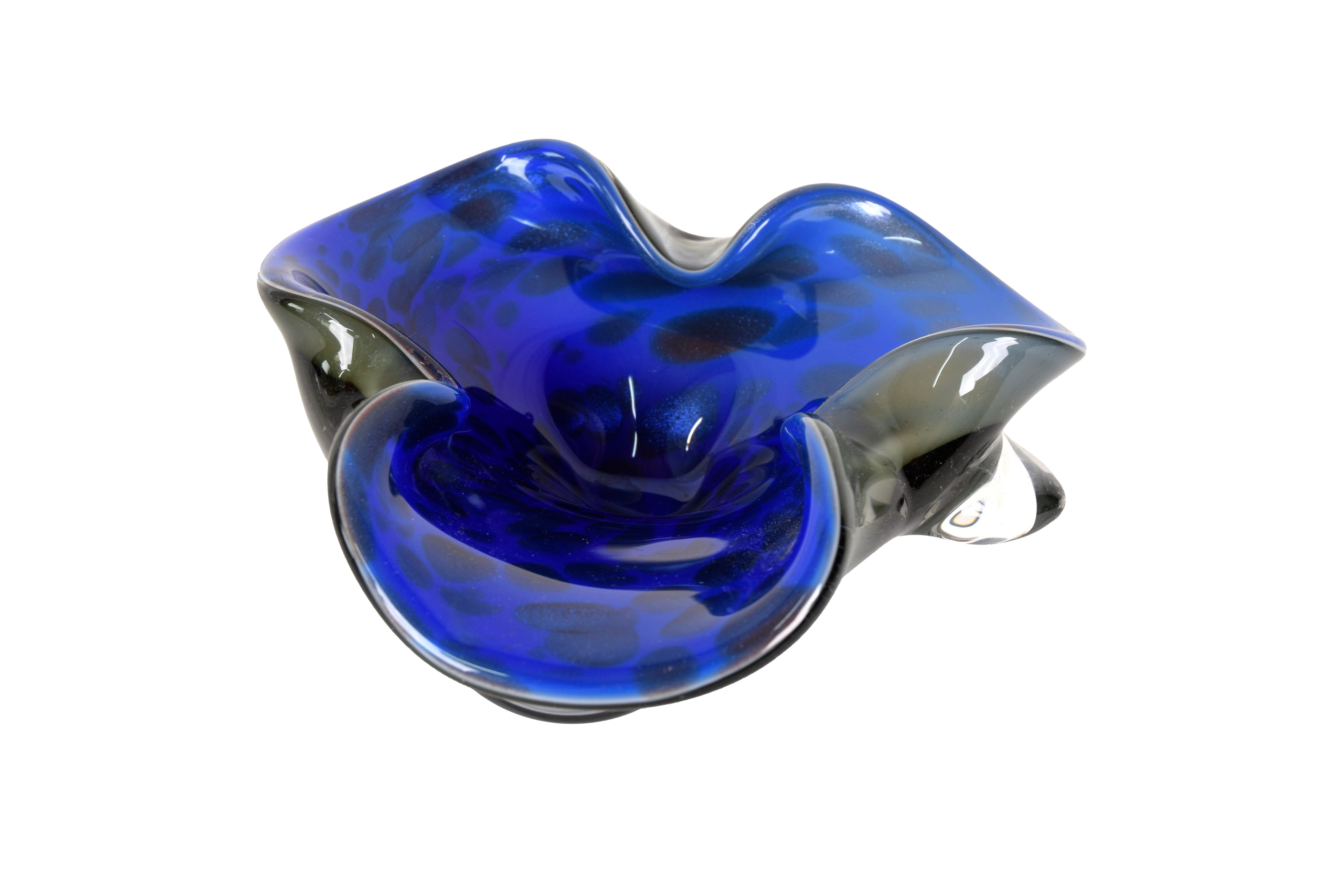 Folded Deep Blue Murano Glass Bowl with Aventurina Detailing

This brightly colored bowl features a beautiful blue interior color overlayed with shimmering areas of aventurina detailing. The underside of the bowl is a subtly milky color and is