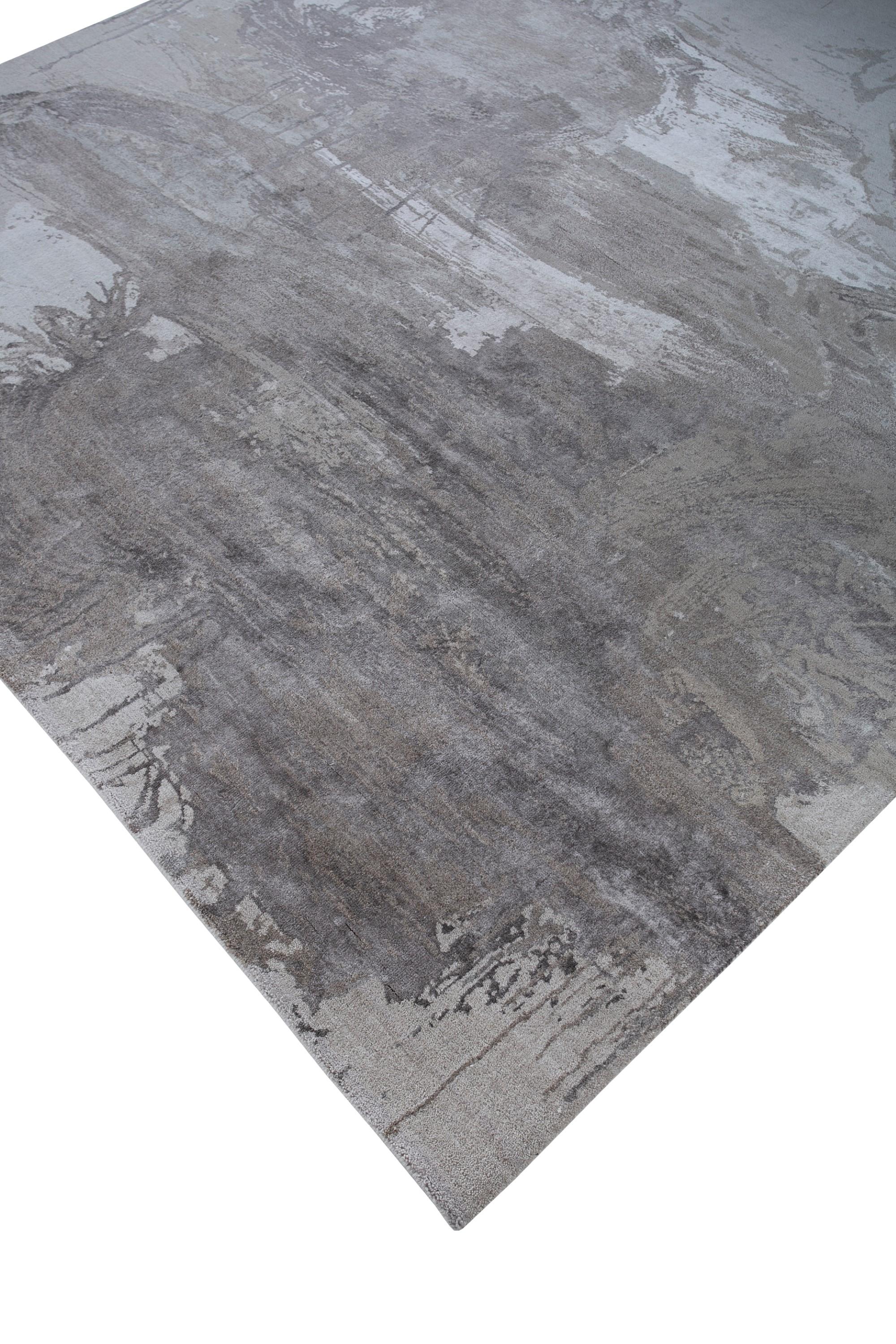 What if a modern masterpiece unfolded beneath your feet? This hand-knotted rug by translates the enigmatic beauty of lost languages into contemporary floor art. Imagine the delicate touch of hand-carded, hand-spun wool and bamboo silk, each knot