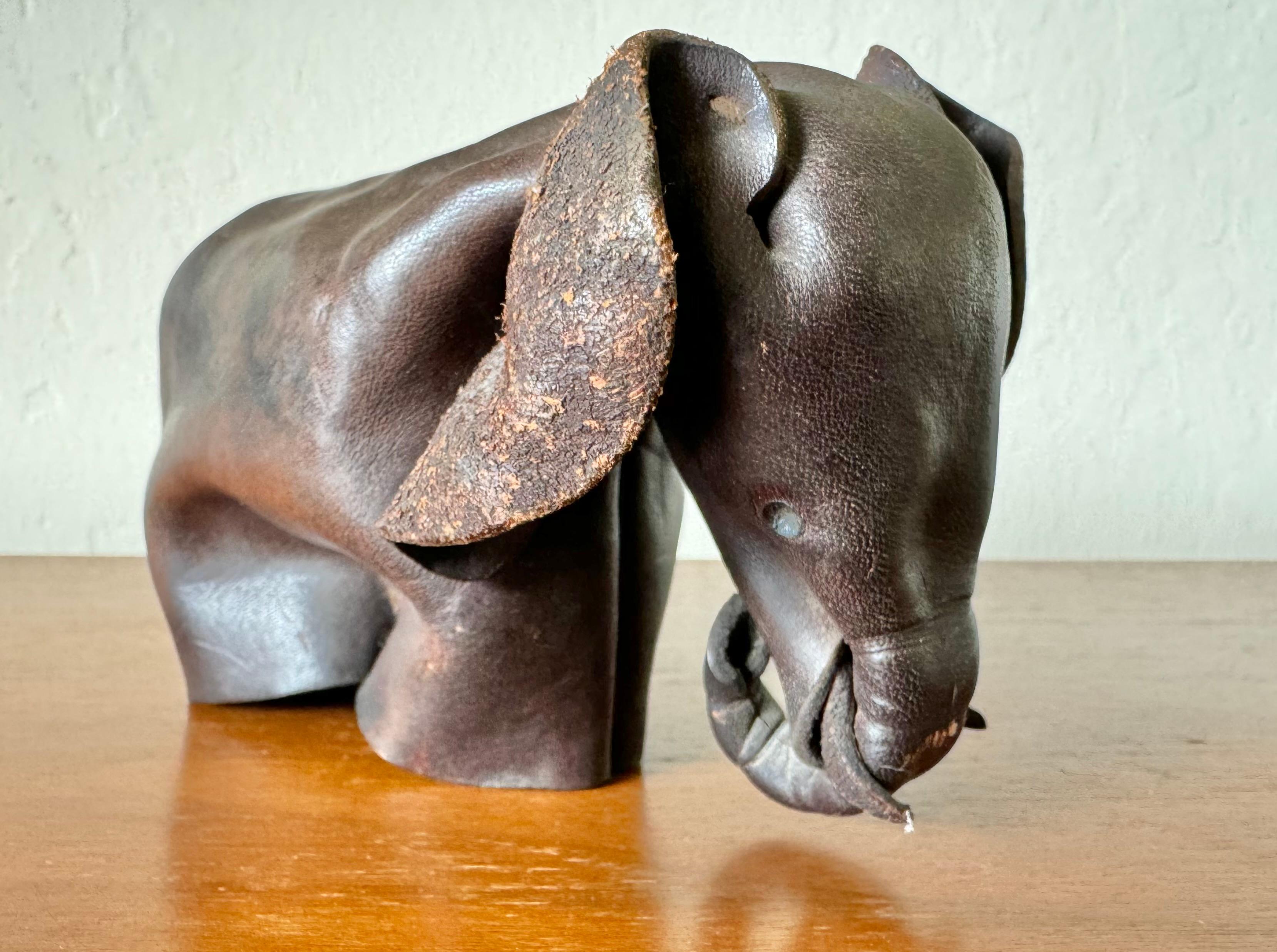 Hand crafted folded leather Elephant from England circa 1960s. A very creative approach using a single piece of leather to make the Elephant form that is folded then stitched together. Stamped 
