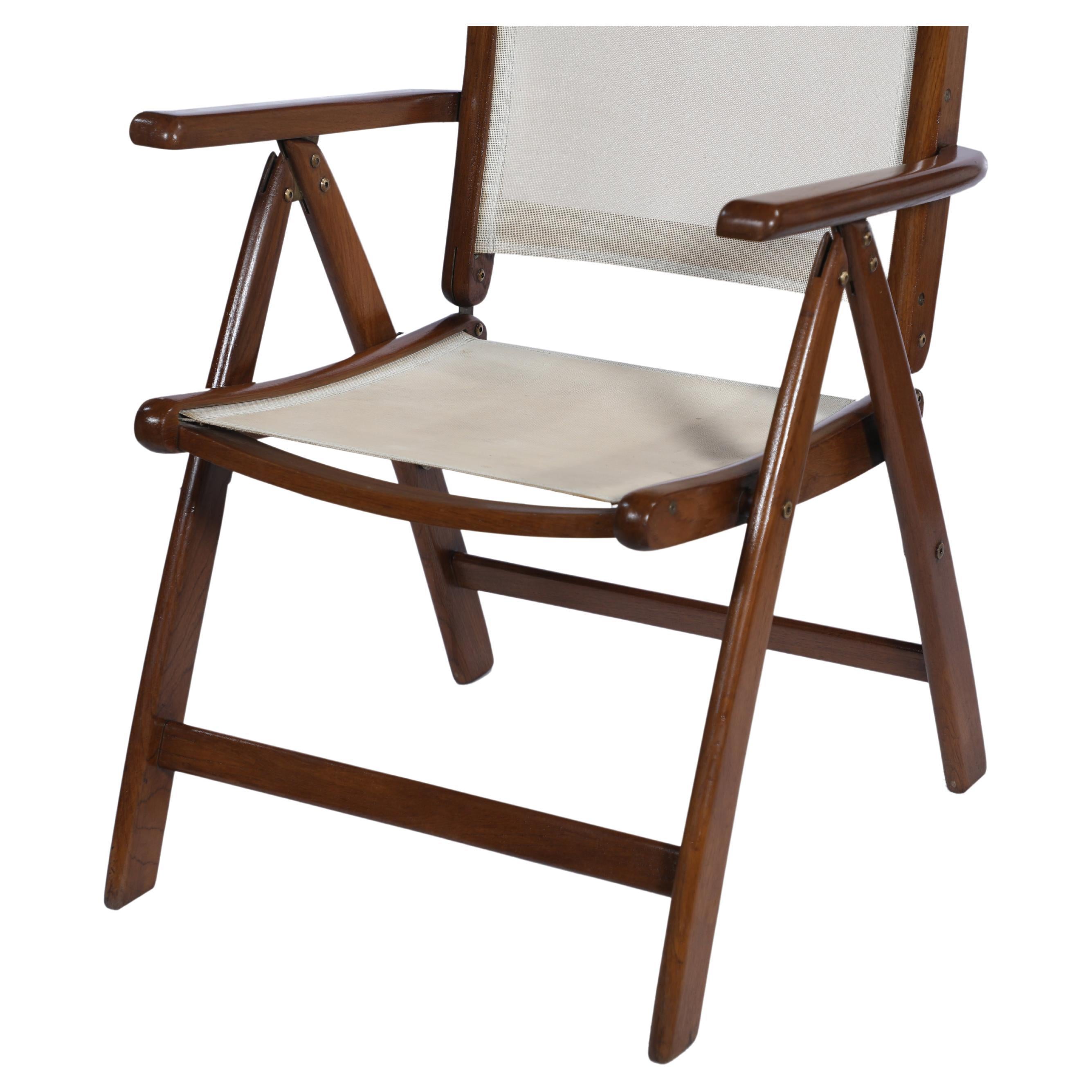 A folding and adjustable teak patio or side chair with an open mesh seat. Easy to add a seat cushion if so desired, originally designed for tropical climates as the open mesh seat would cool the body. Colonial British. 1960s.