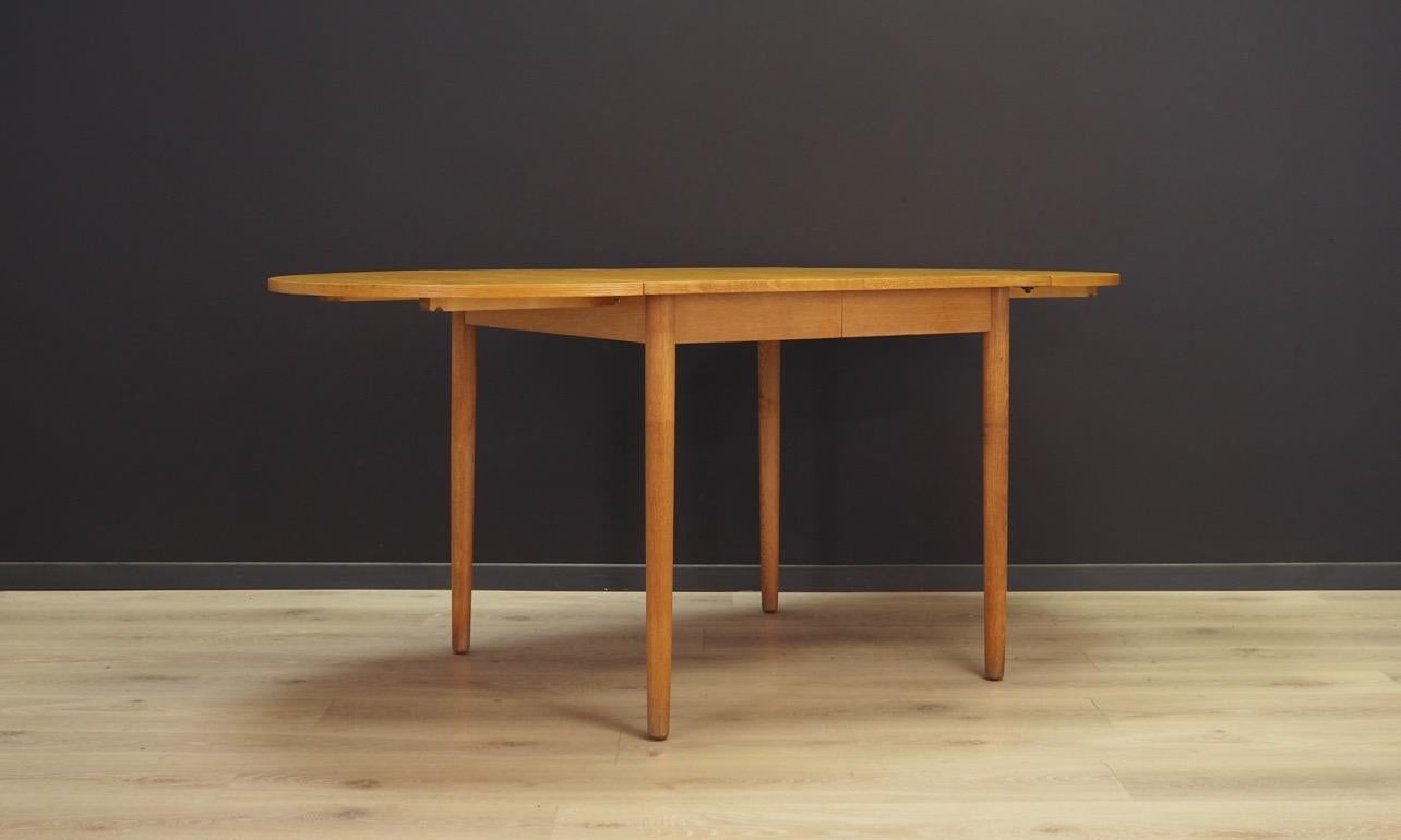 Minimalistic table from the 1960s-1970s, Danish design. Classic table with ash veneer. Ash legs. Inserts can be hidden under the main panel. Table in good condition (minor scratches and dings) - directly for use. 

Dimensions: height 72.5 cm