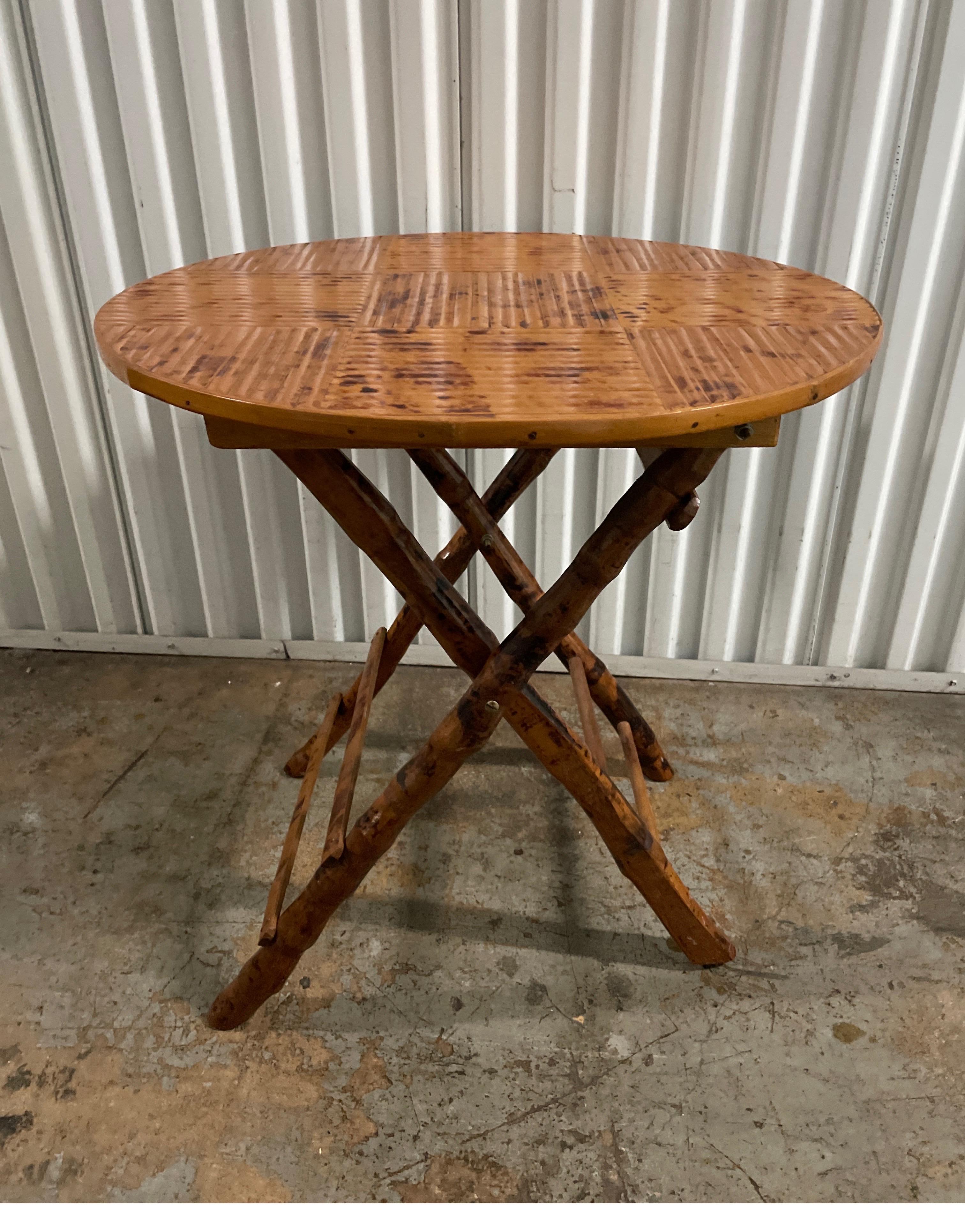 Folding burnt bamboo folding campaign table with split bamboo top. Great for end table, nightstand or for entertaining.