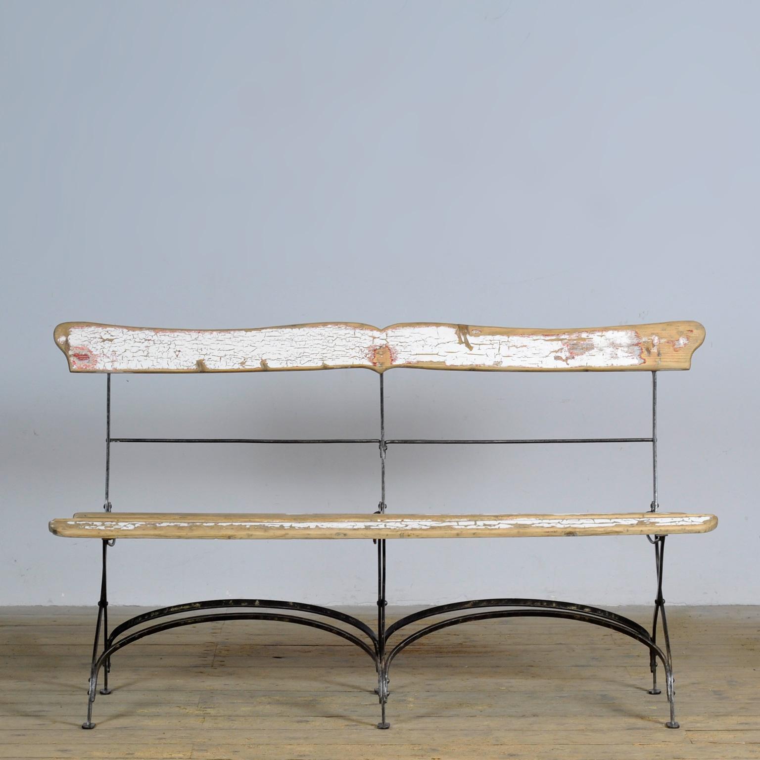 Bench from the 1900s, made in France. The bench has a riveted iron base with wooden slats. The special thing about this bench is that it is foldable.