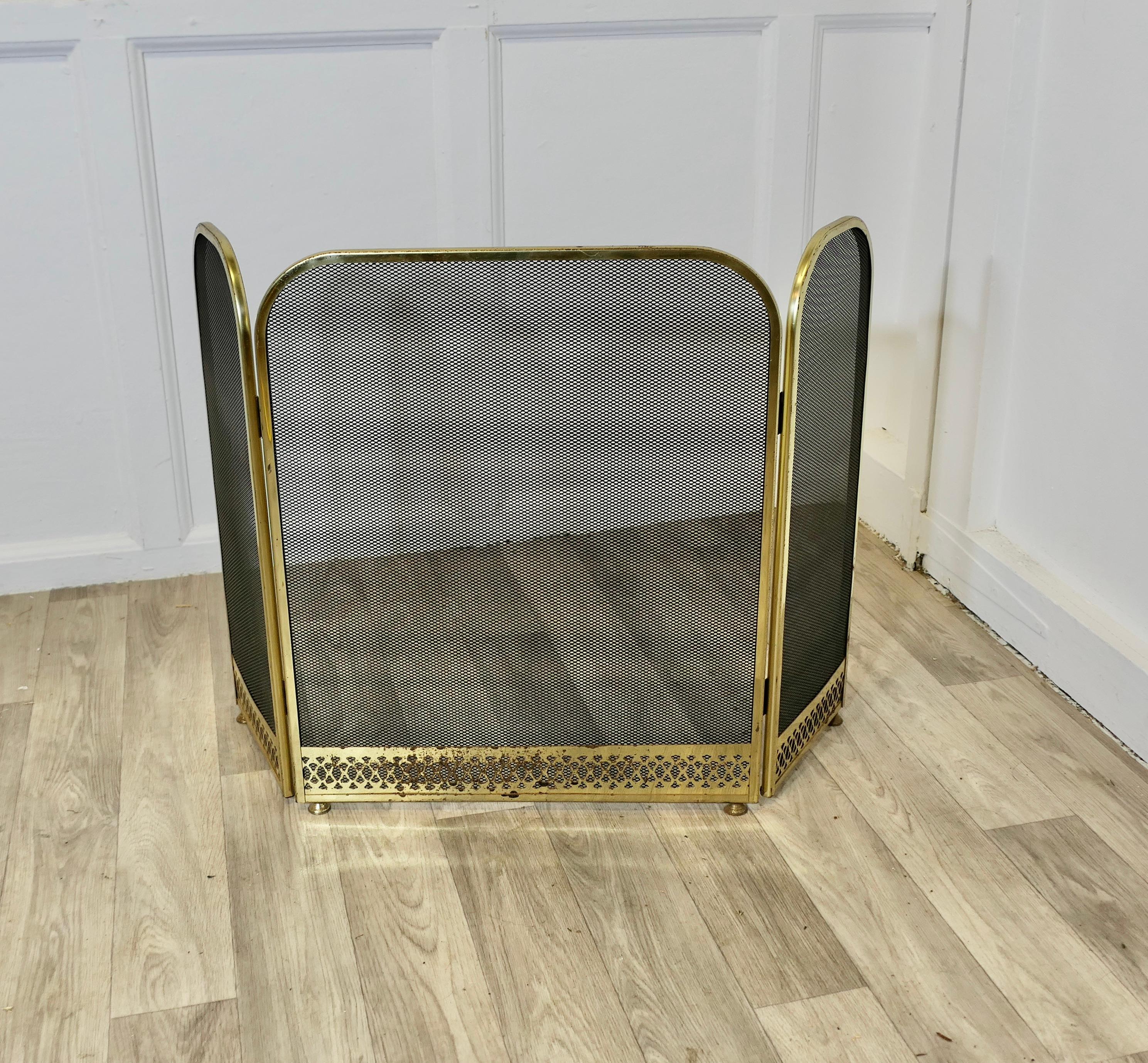 Folding Brass Fire Guard, Spark Guard 

This very useful spark guard has a brass frame and a fine mesh infill decorated with a decorative pierced brass border along the bottom, it has the added advantage that it folds flat for storage, and when