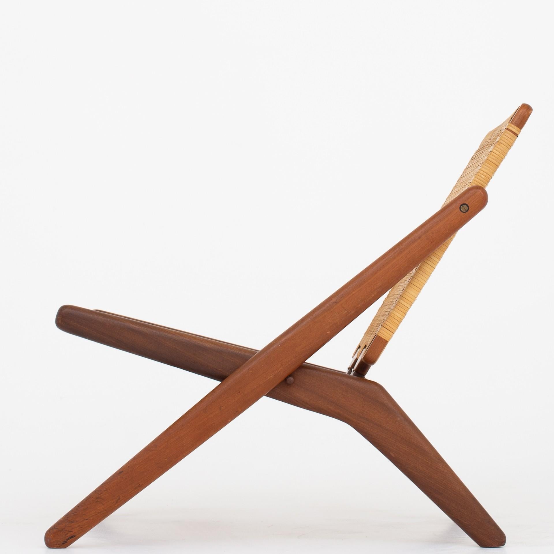 Folding chair in teak with original cane, circa 1957. Maker Jutex.