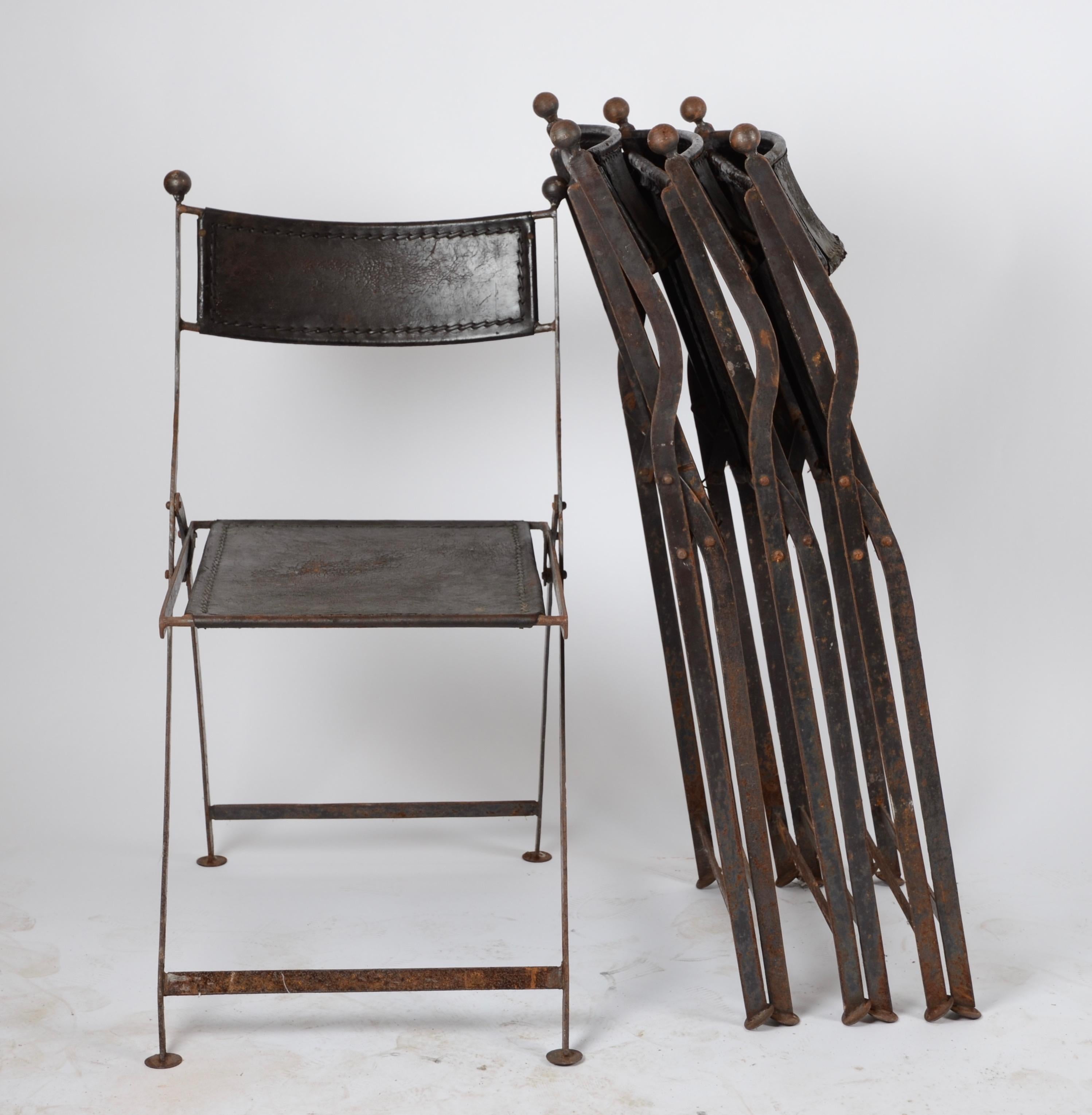 A set of four folding chairs in leather and iron, France, 1920s-1930s.