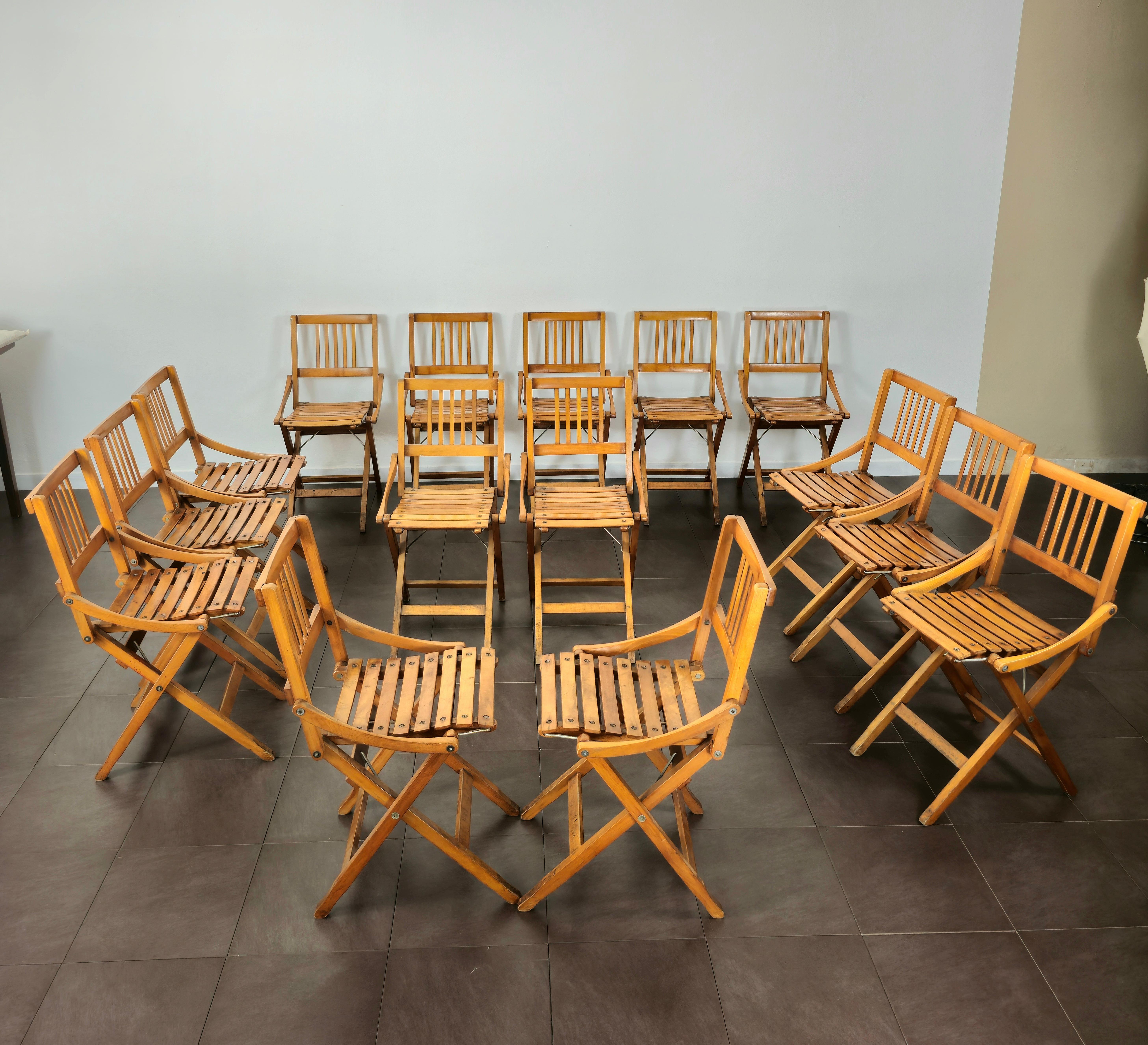 Rare set of 15 folding wooden chairs not to be confused with the small ones for children, produced in Italy in the 1950s / 60s by the Fratelli Reguitti. The chairs can also be placed for outdoor environments.