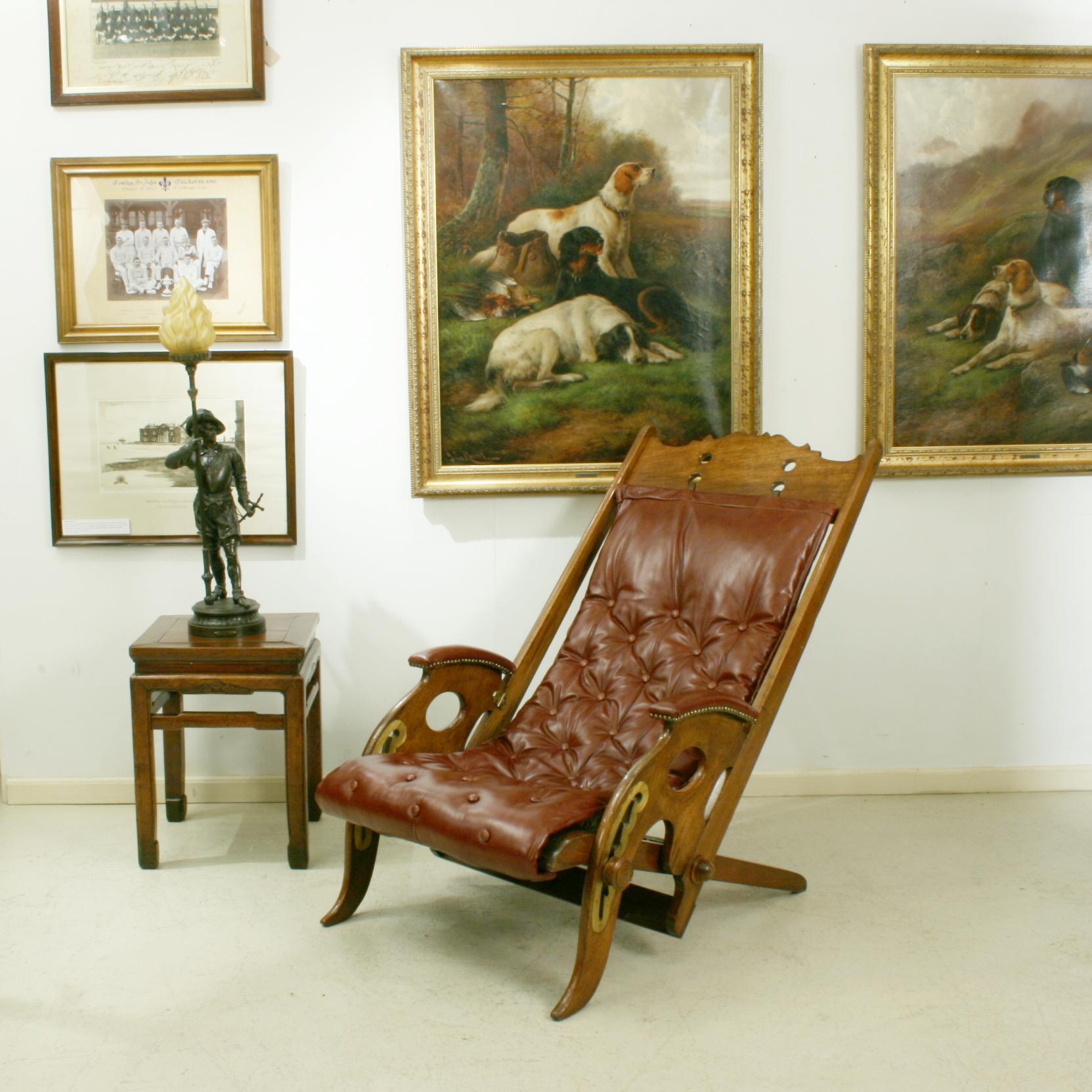 Reclining colonial campaign Chair.
A wonderful Anglo-Indian folding chair with an oxblood red leather slung seat and leather padded arms. The original design of this type of chair is attributed to J. Herbert McNair, he was part of the influential
