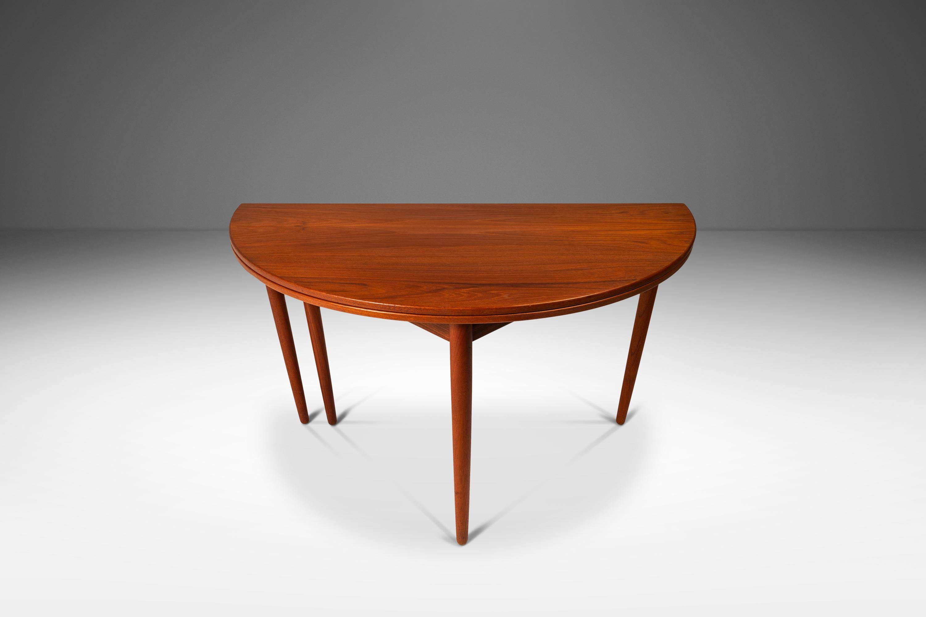 This rare and innovative Danish Modern table, designed by Poul Volther and manufactured by Frem Røjle in the 1960s, exemplifies the elegance and practicality of mid-century design. Crafted from rich teak, this table features a unique folding