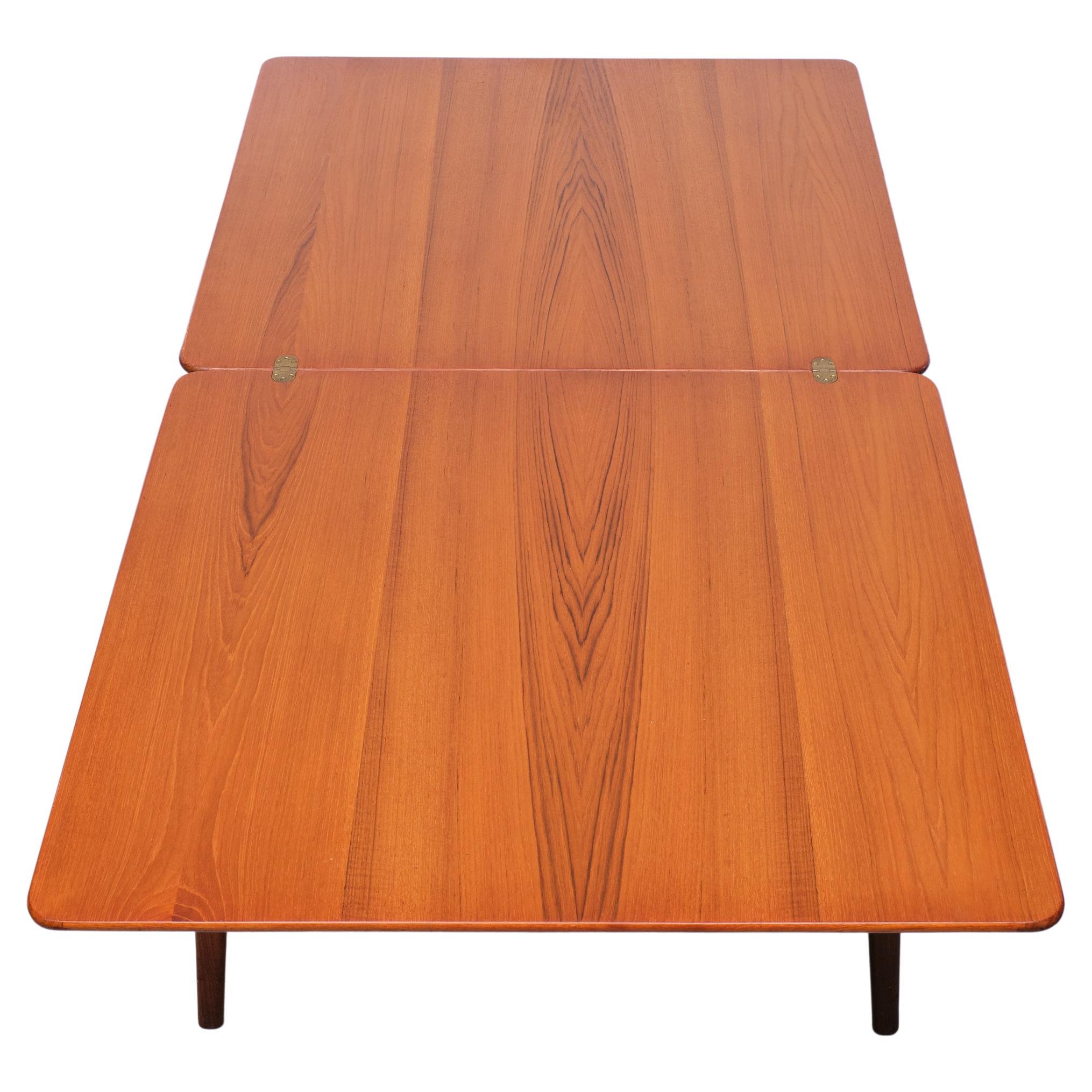 Beautiful dining table. Design by Louis Van Teeffelen for Wébé 1960s 
Very rare model. Pull out the legs and Simply folding out the top. 100cm /200 cm 
Superb grain on the Teak wood. Brass hinges. Signed.