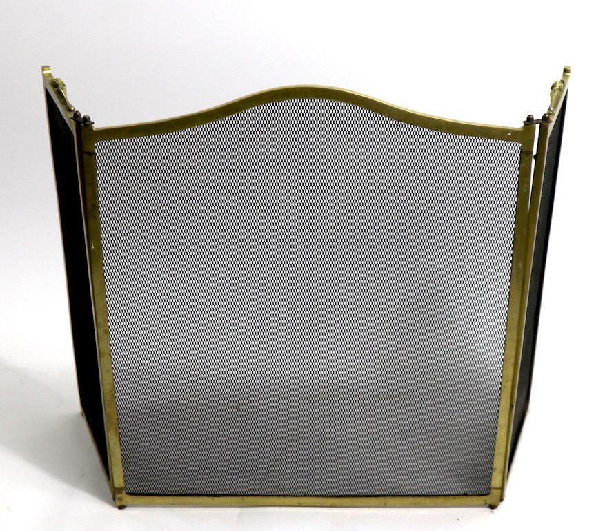 Extra grade folding fireplace screen with solid cast brass frame, and metal mesh screen. Most folding screens have hollow stock frames, making them less substantial and well made, this is an unusually well constructed high quality screen. Each side