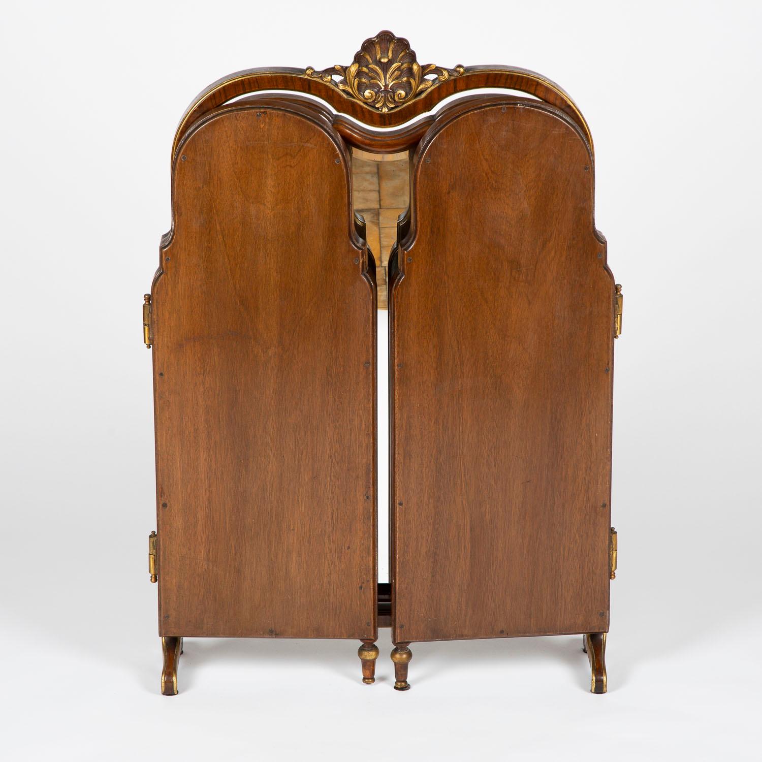A French carved walnut folding tripartite dressing table mirror with gilt decoration.

The 3 mirrors are have beveled edges. The angle of the central mirror can be adjusted, and both the outer mirrors can removed.

Measures: Width when fully