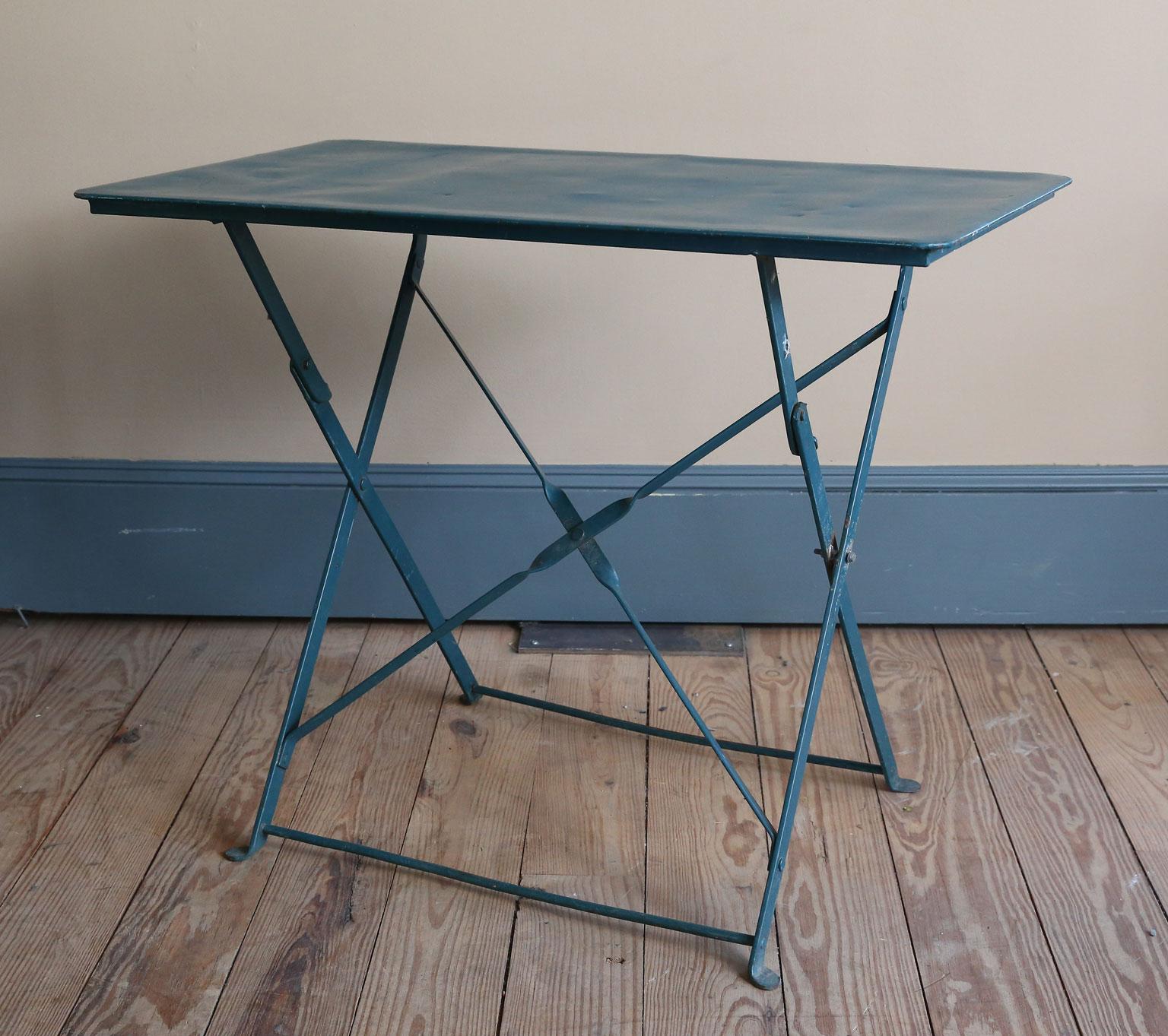 The table has been painted at some time in its life. We have two of them. They are folding tables that are of nice, heavy quality. These tables could be used as a small desk, as a side table, as a serving table, etc. They are kind of nice because