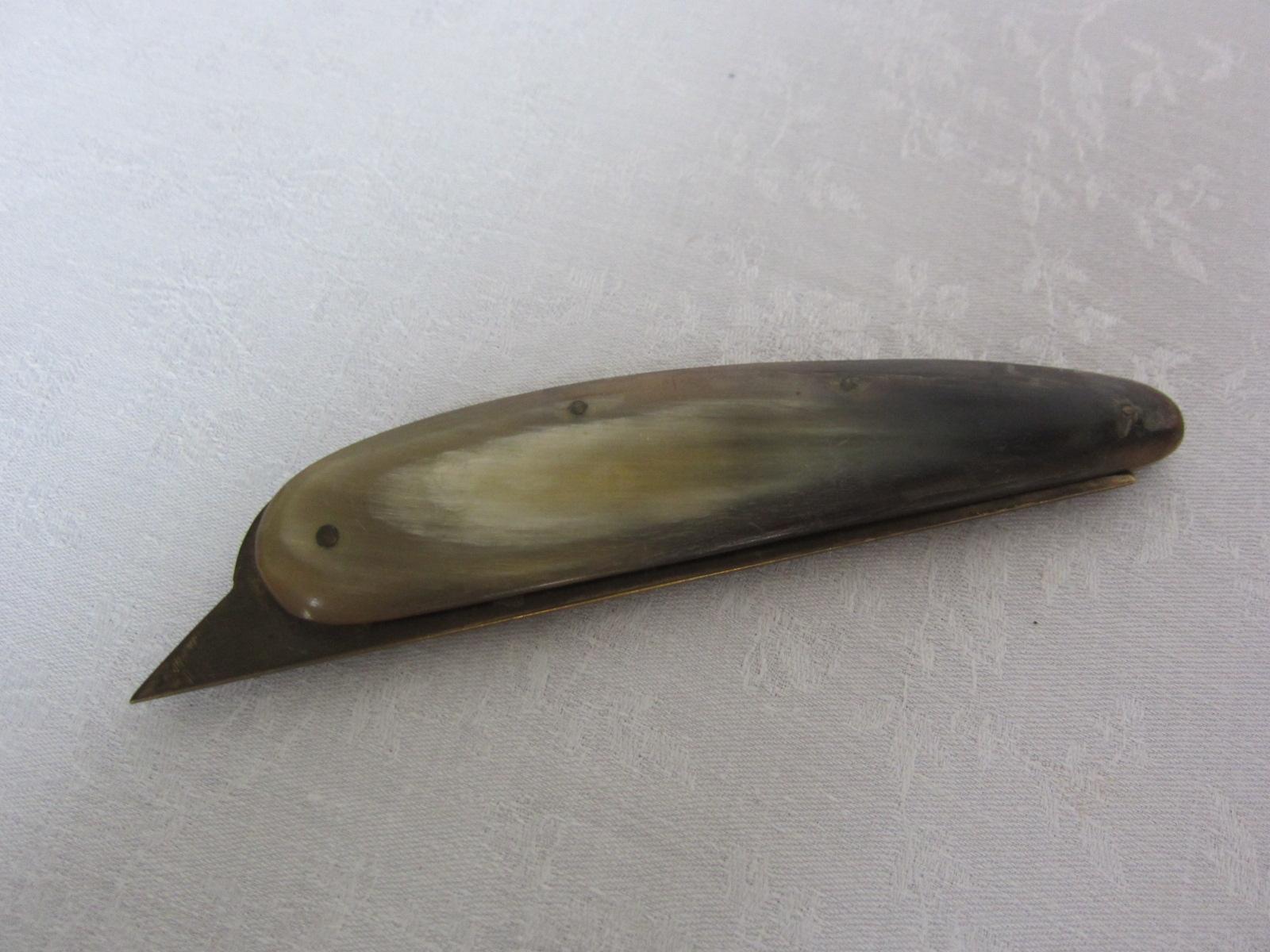 This Folding knife or letter opener made from brass with horn handle; marked on the blade: Auböck Made Vienna/Austria; signs of age and use, slightly scratched, the handle is made from Nepalese water buffalo horn, slightly corroded; length when